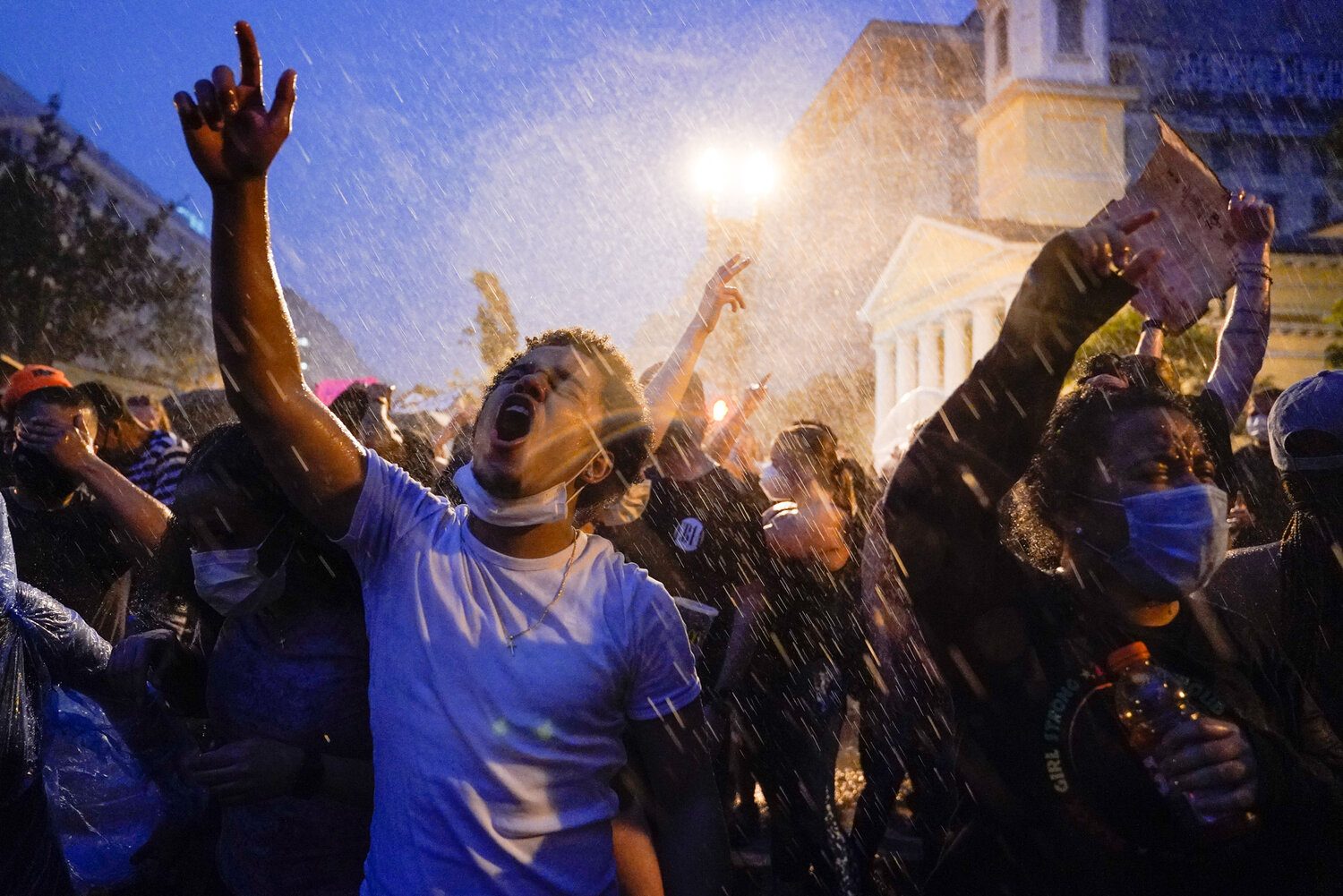  People protest in the rain near the White House in Washington on June 4, 2020, over the death of George Floyd, a Black man who died in Minneapolis after a white police officer pressed a knee into his neck for several minutes. (AP Photo/Evan Vucci) 