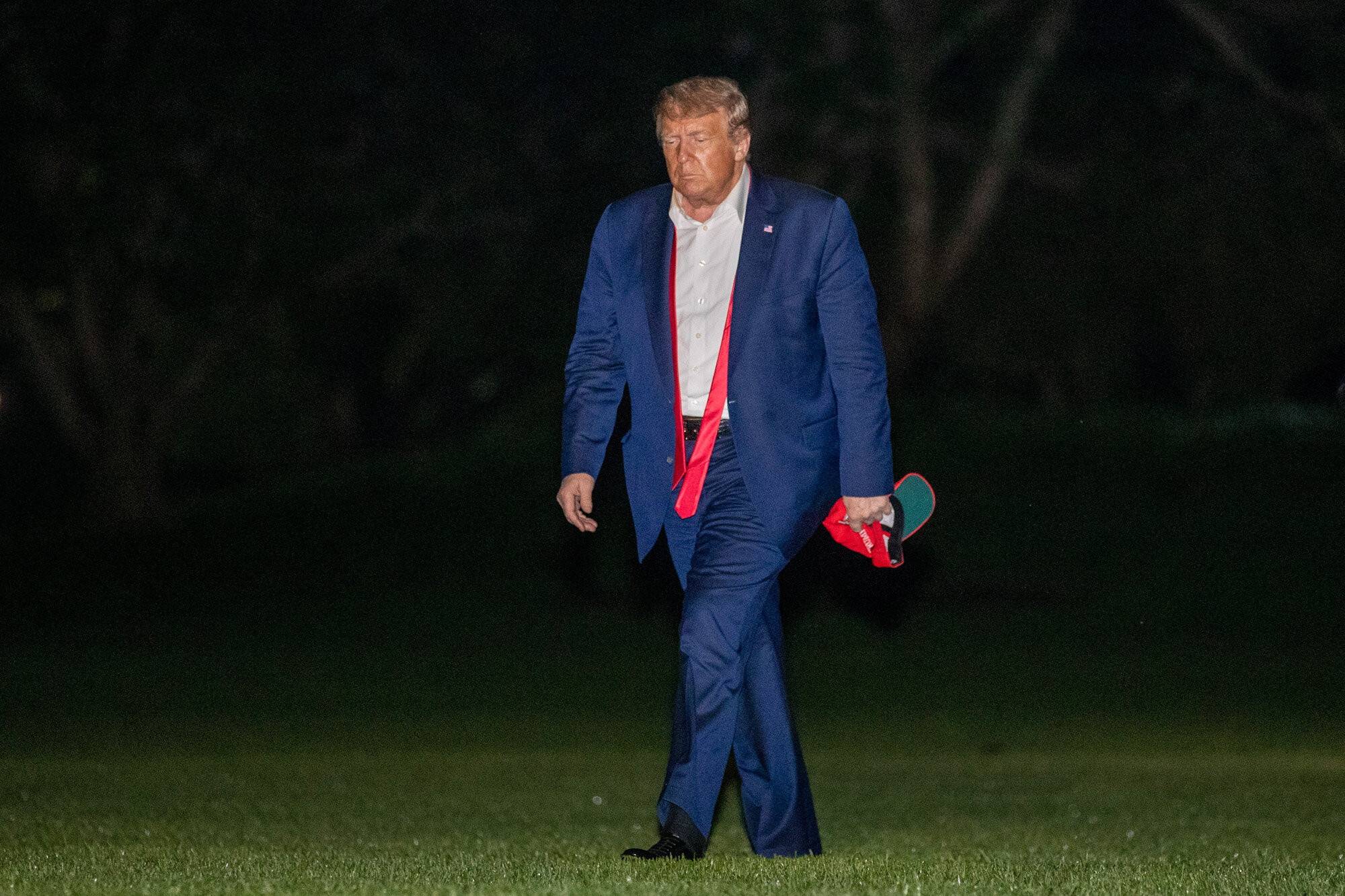 President Donald Trump, returning from a campaign rally in Tulsa, Okla., walks across the South Lawn of the White House in Washington after stepping off the Marine One helicopter, early Sunday, June 21, 2020. (AP Photo/Patrick Semansky)