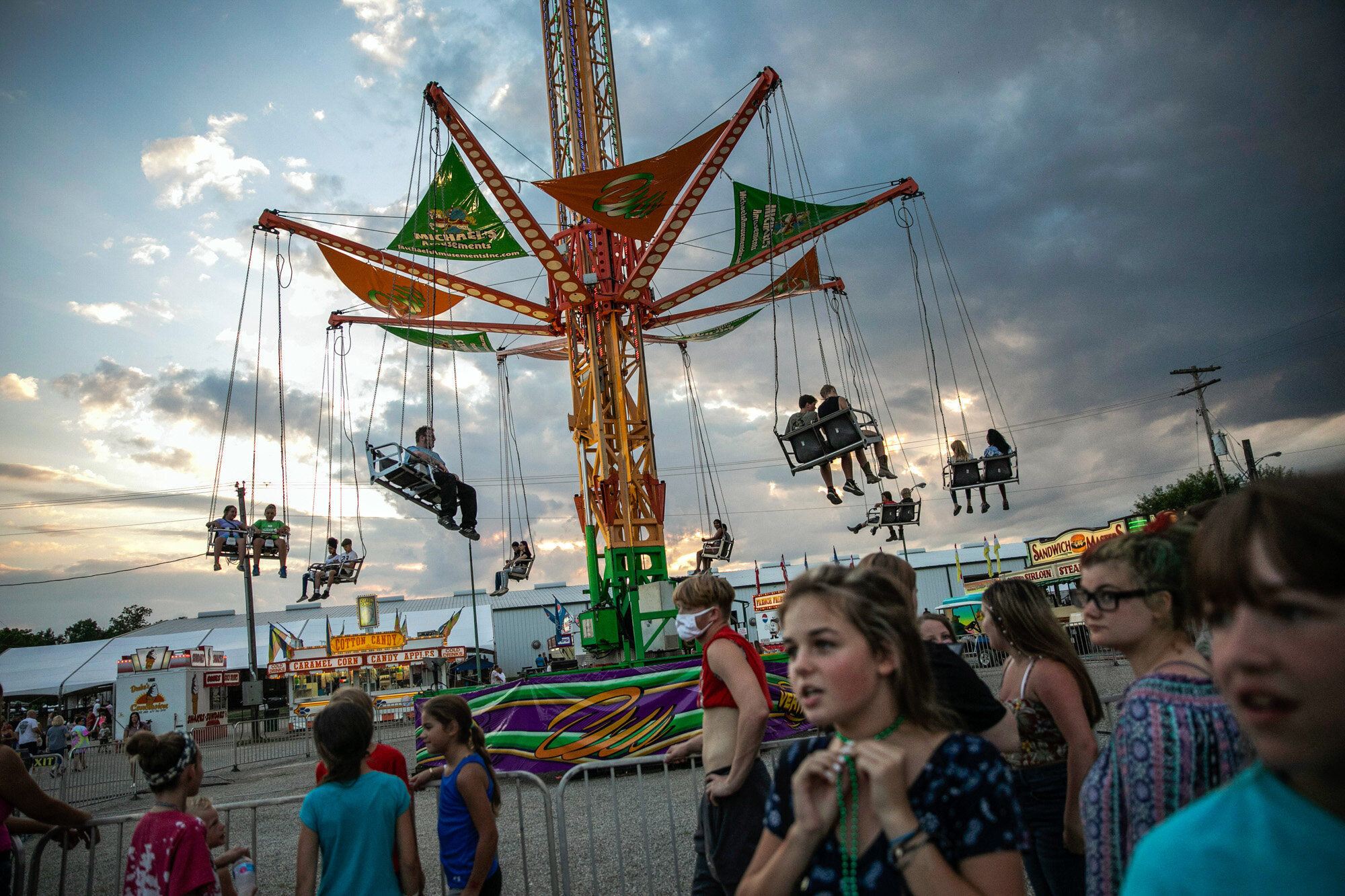 People wait to ride a revolving swing at the Perry State Fair in New Lexington, Ohio, on July 24, 2020. (AP Photo/Wong Maye-E)