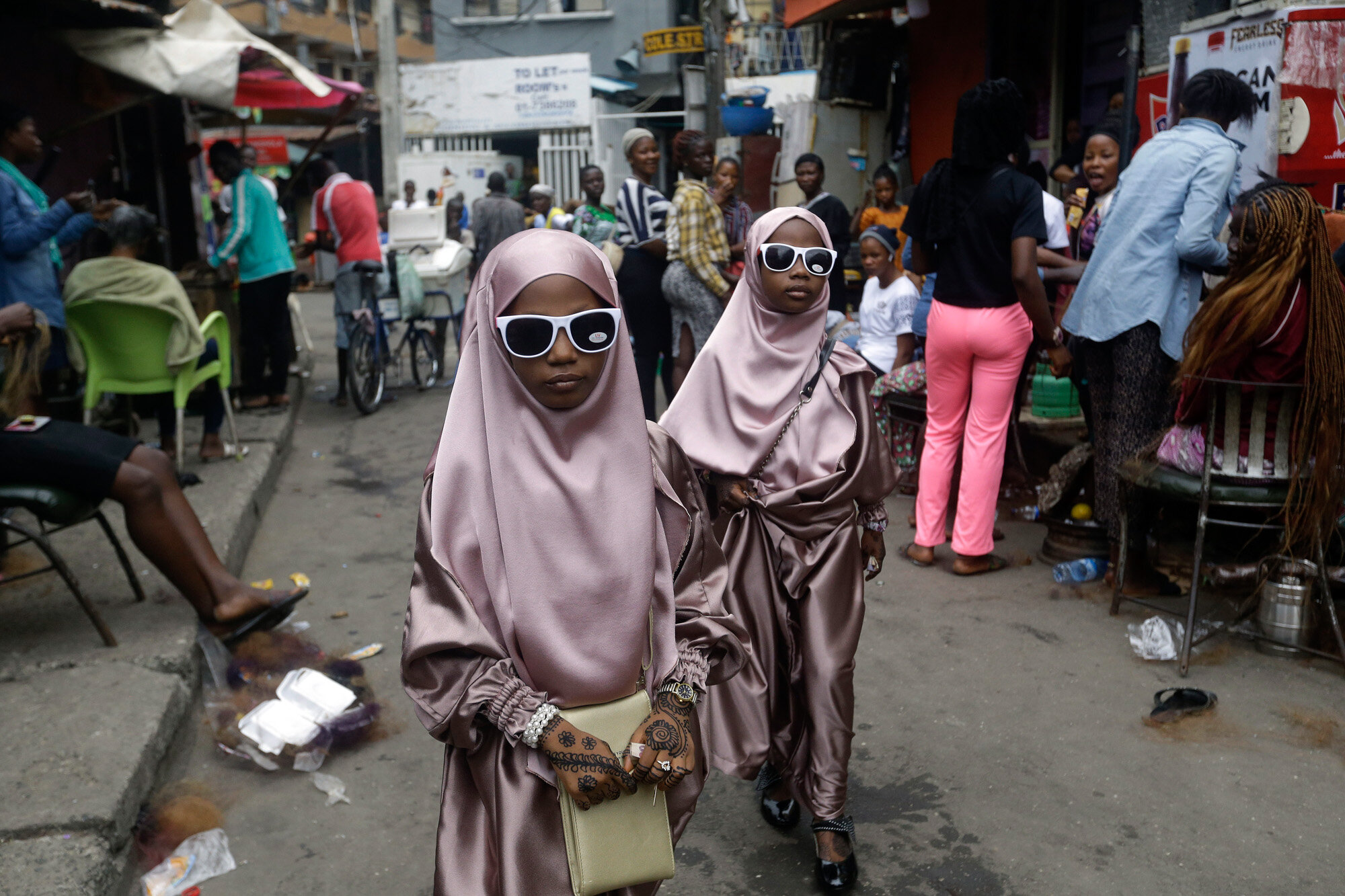 Muslim girls walk down the street after prayers in Lagos, Nigeria, on July 31, 2020, as Muslims worldwide marked the start of Eid al-Adha, or "Feast of Sacrifice," in which Muslims slaughter livestock and distribute the meat to the poor. (AP Photo/Sunday Alamba)