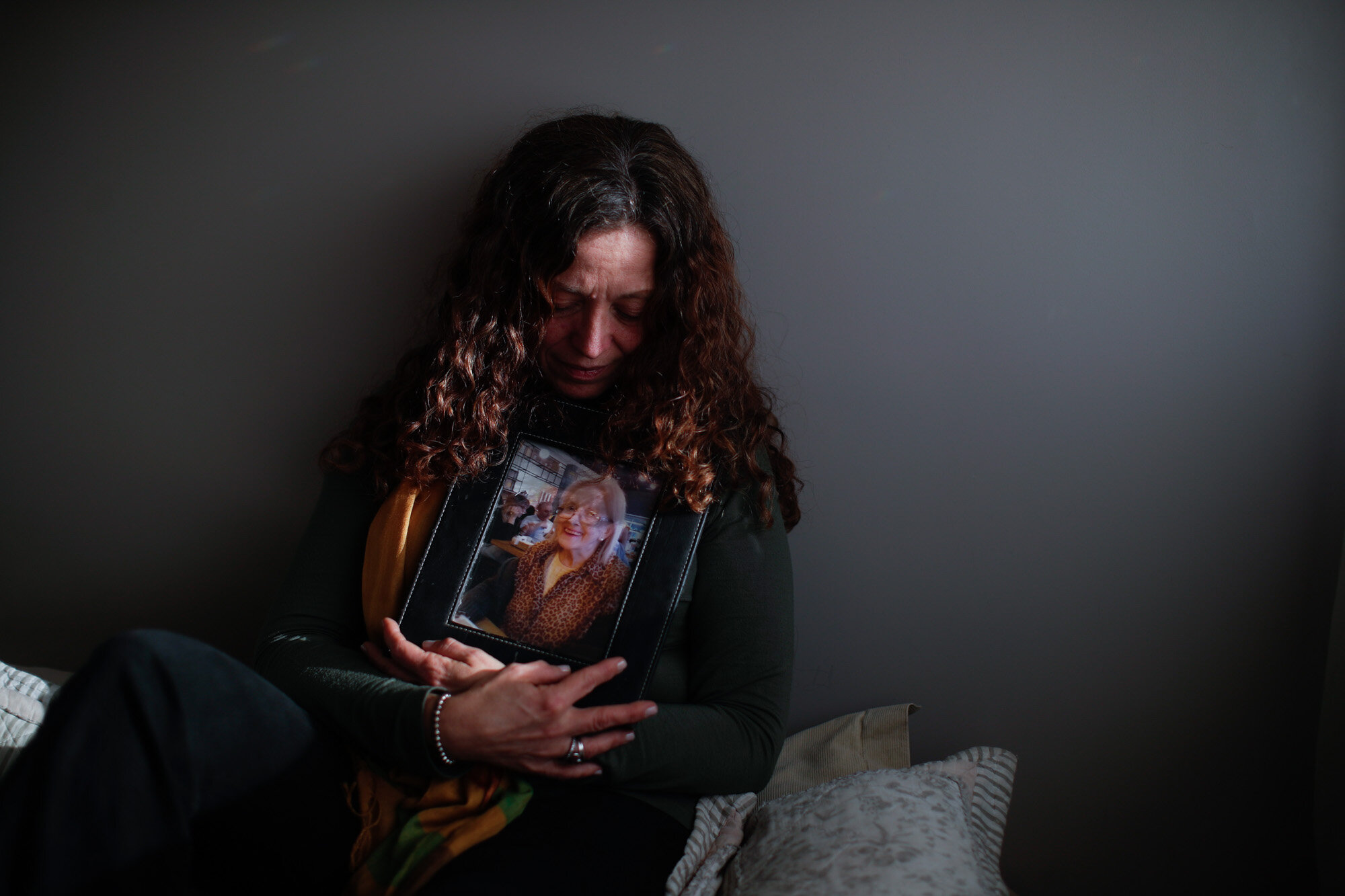  Fernanda Mariotti poses for a photo with a picture of her mother, Martha Pedrotti, who died of COVID-19, at her home in Buenos Aires, Argentina, on Aug. 11, 2020. Although Mariotti insisted on seeing her mother at the hospital, the doctor refused to