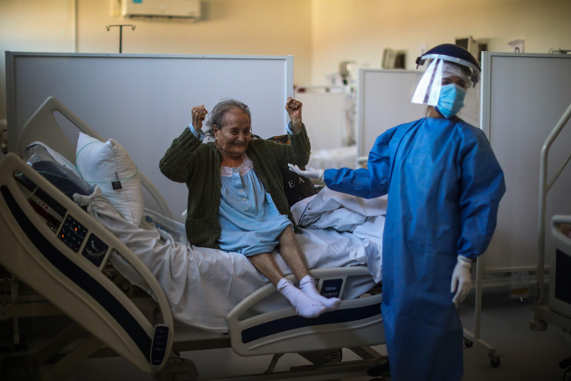  Blanca Ortiz, 84, celebrates after learning from nurses that she will be dismissed from the Eurnekian Ezeiza Hospital, on the outskirts of Buenos Aires, Argentina, on Aug. 13, 2020, several weeks after being admitted with COVID-19. (AP Photo/Natacha