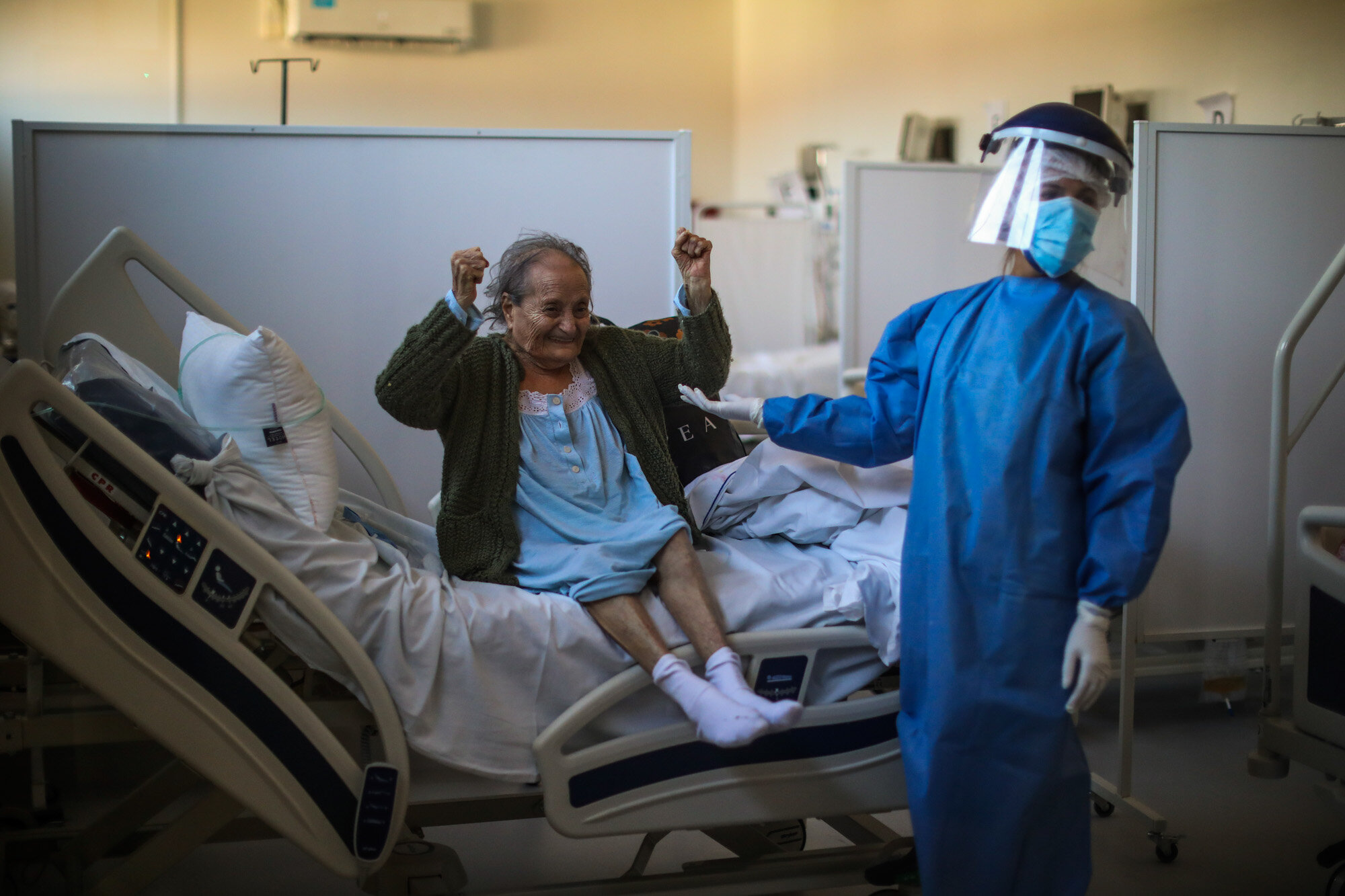 Blanca Ortiz, 84, celebrates after learning from nurses that she will be dismissed from the Eurnekian Ezeiza Hospital, on the outskirts of Buenos Aires, Argentina, on Aug. 13, 2020, several weeks after being admitted with COVID-19. (AP Photo/Natacha Pisarenko)
