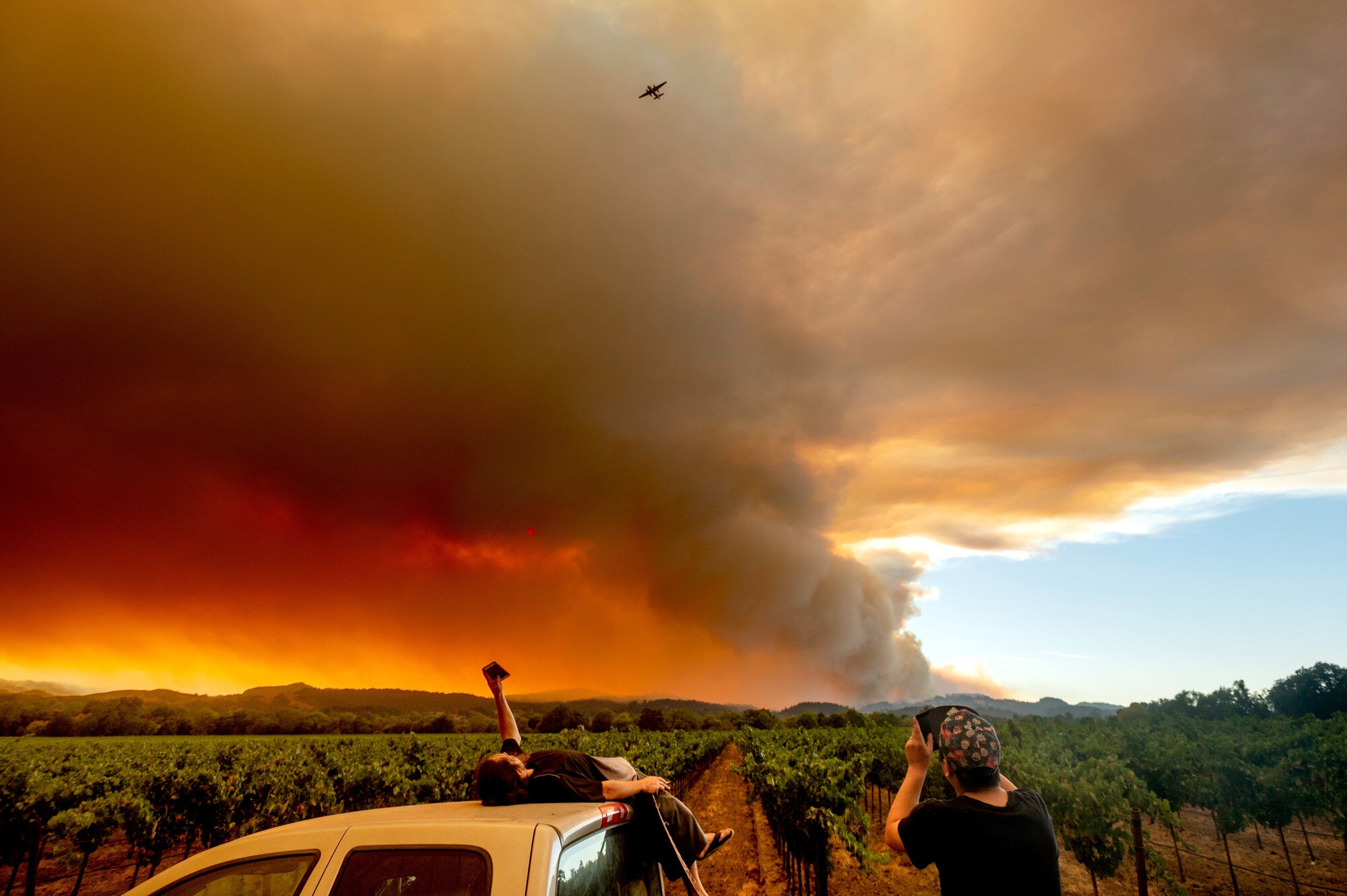  Thomas Henney, left, and Charles Chavira watch a plume of smoke spread over Healdsburg, Calif., as wildfires burn nearby on Aug. 20, 2020. Deadly wildfires in California more than doubled the previous record for the most land burned in a single year