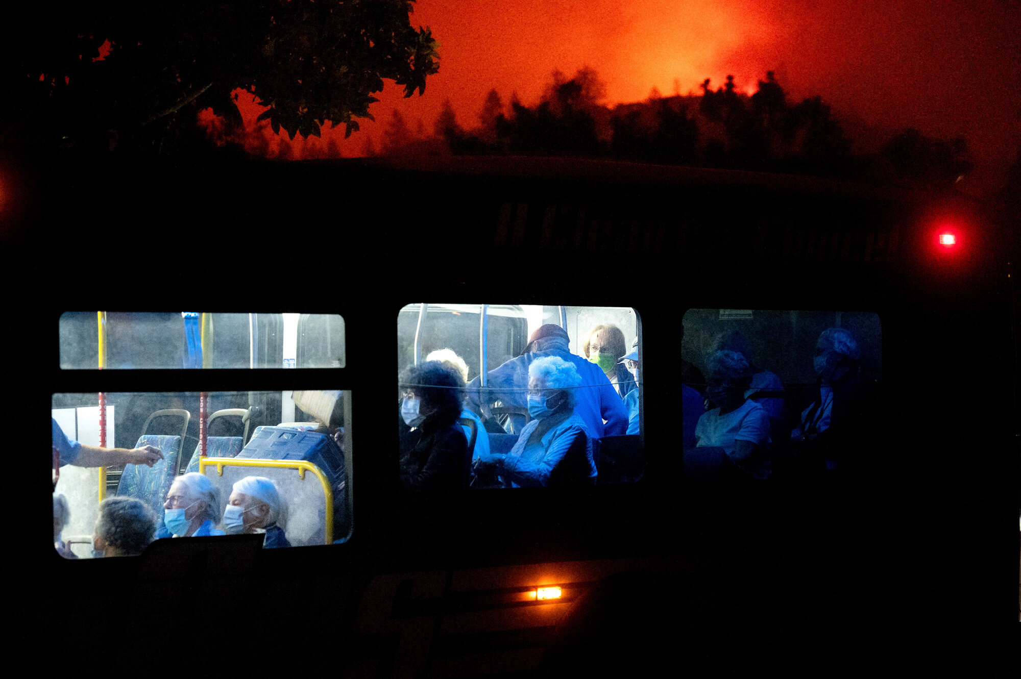 Residents of the Oakmont Gardens senior home evacuate on a bus as the Shady Fire approaches in Santa Rosa Calif., on Sept. 28, 2020. (AP Photo/Noah Berger)
