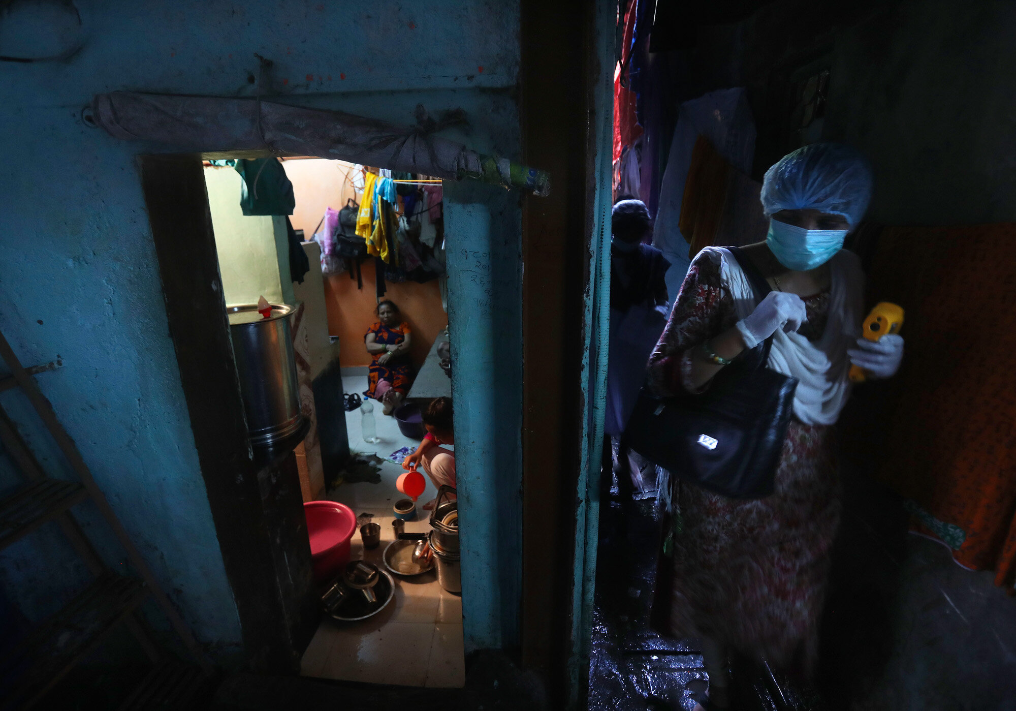 A health worker arrives to screen people for symptoms of COVID-19 on Sept. 4, 2020, in Dharavi, one of Asia's biggest slums, in Mumbai, India. (AP Photo/Rafiq Maqbool)