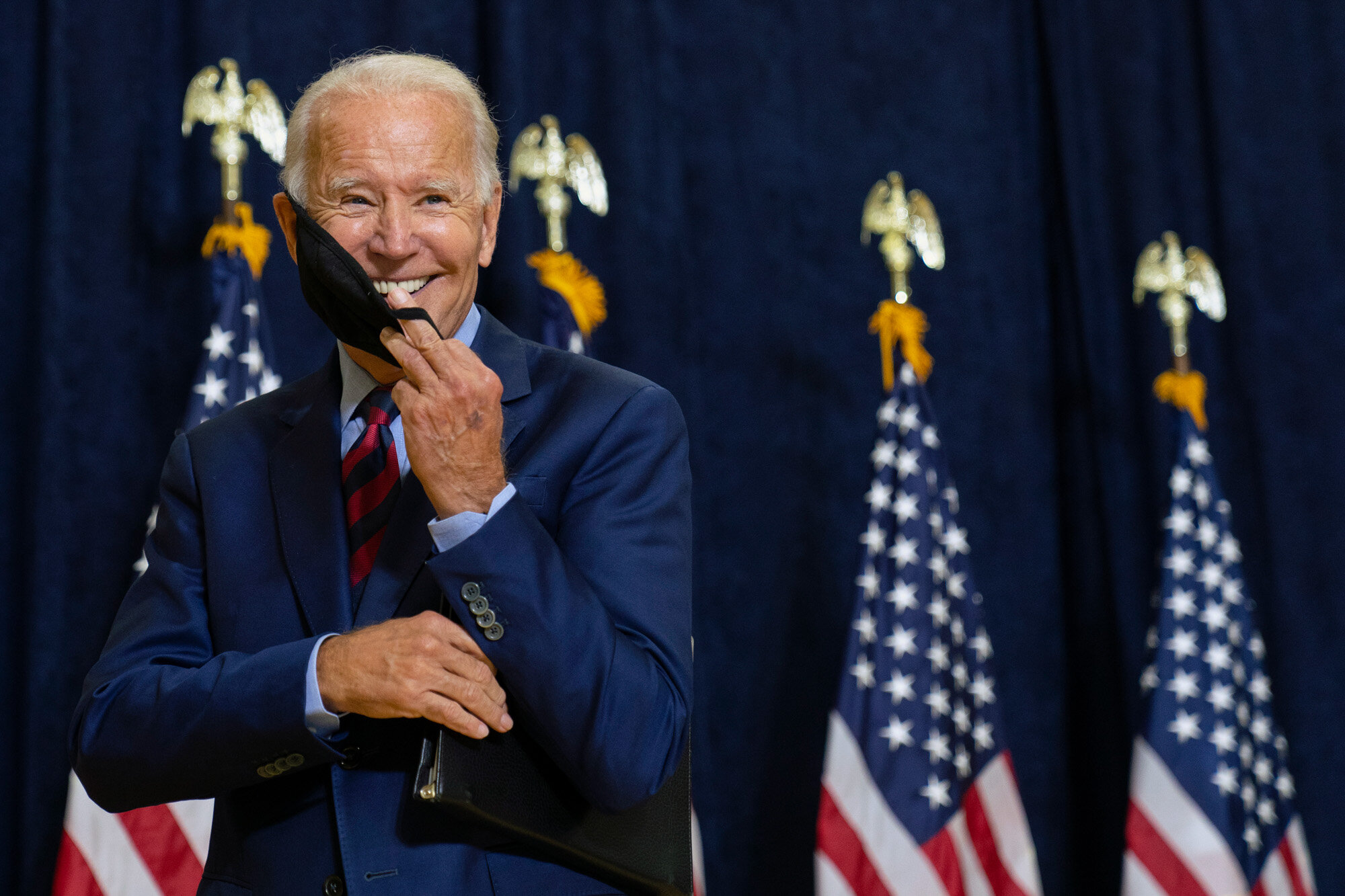 Democratic presidential candidate former Vice President Joe Biden smiles as he puts on his face mask after speaking to media in Wilmington, Del., on Sept. 4, 2020. (AP Photo/Carolyn Kaster)