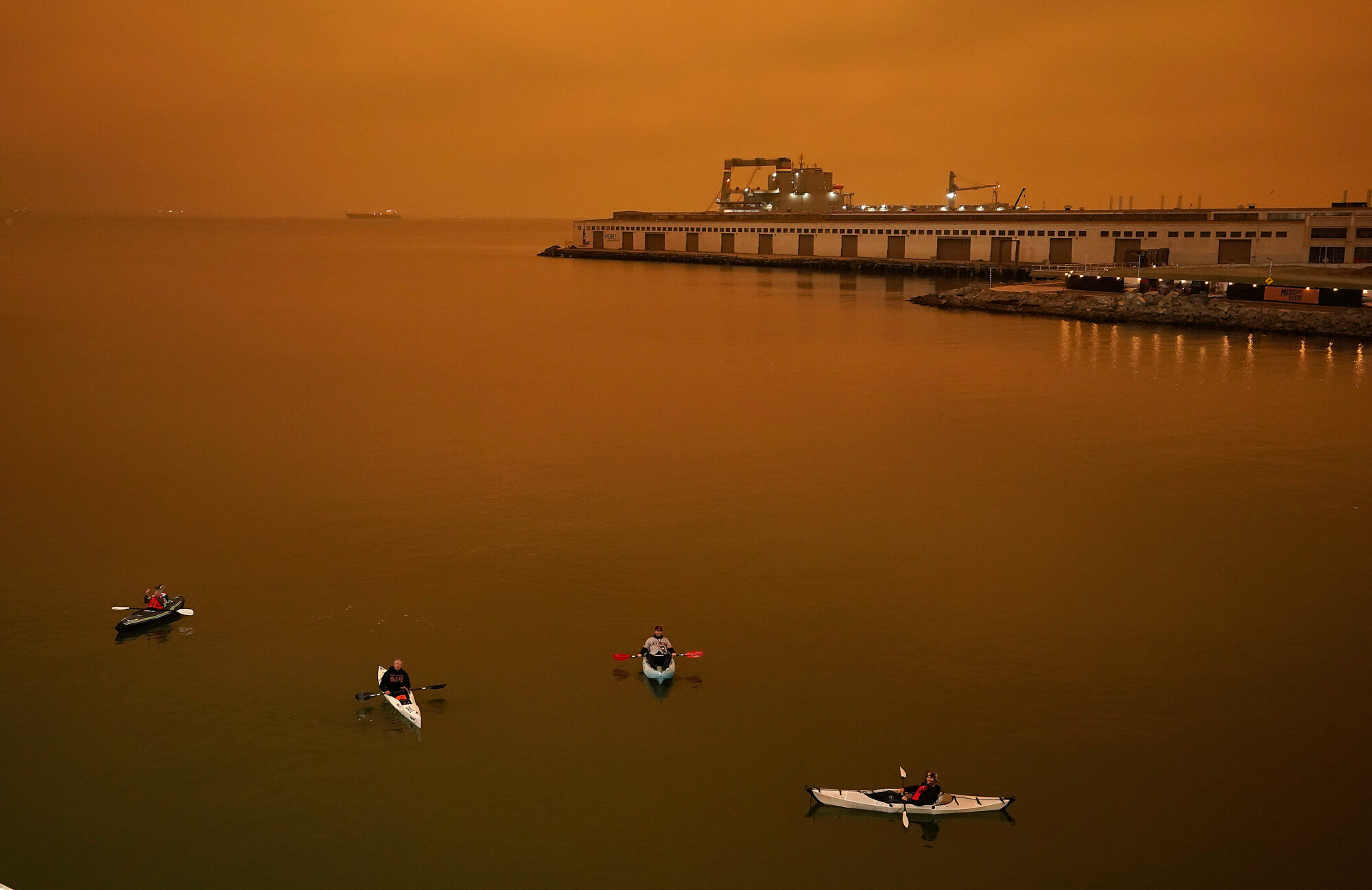 People in kayaks paddle in McCovey Cove outside Oracle Park in San Francisco during a baseball game between the San Francisco Giants and the Seattle Mariners on Sept. 9, 2020. (AP Photo/Tony Avelar)