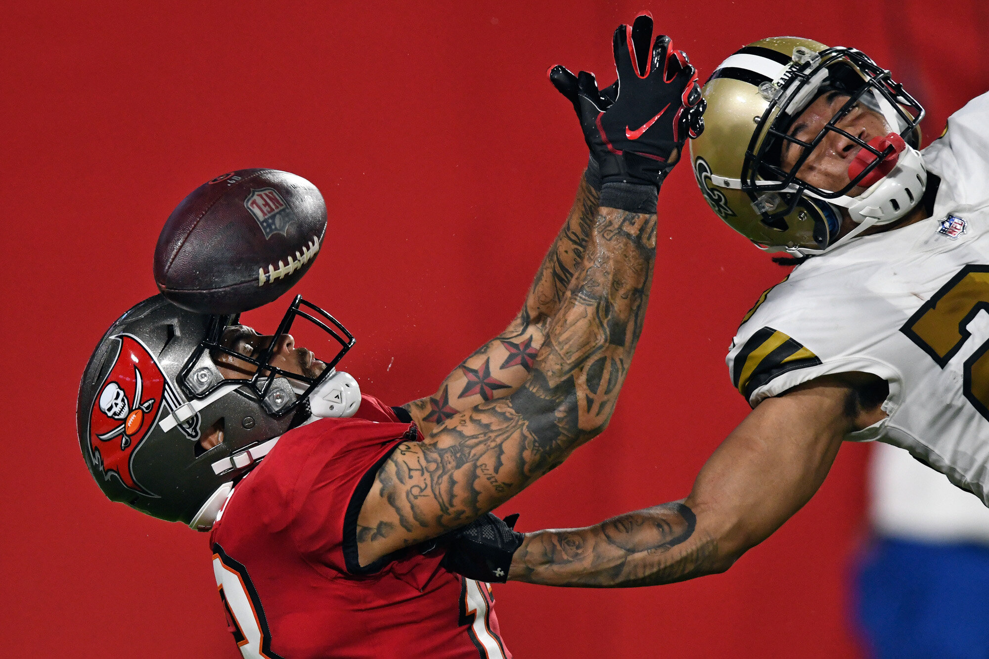  New Orleans Saints cornerback Marshon Lattimore, right, knocks the ball away from Tampa Bay Buccaneers wide receiver Mike Evans in the end zone on a fourth down during the second half of an NFL football game on Nov. 8, 2020, in Tampa, Fla. (AP Photo