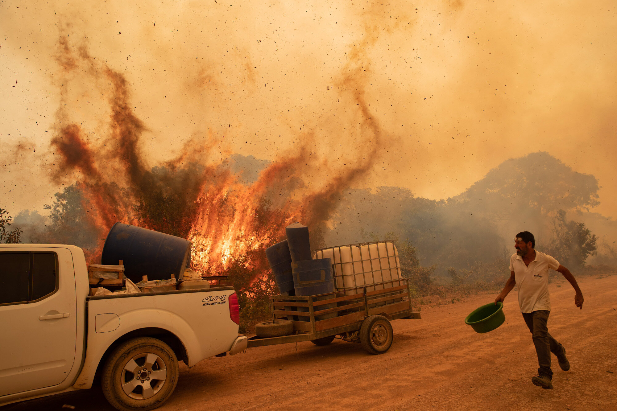 A volunteer tries to douse a fire on Transpantaneira road in the Pantanal wetlands near Pocone, Mato Grosso state, Brazil, on Sept. 11, 2020. The number of fires in Brazil's Pantanal, the world's biggest tropical wetlands, more than doubled in the first half of 2020 compared to the same period last year, according to data released by a state institute. (AP Photo/Andre Penner)
