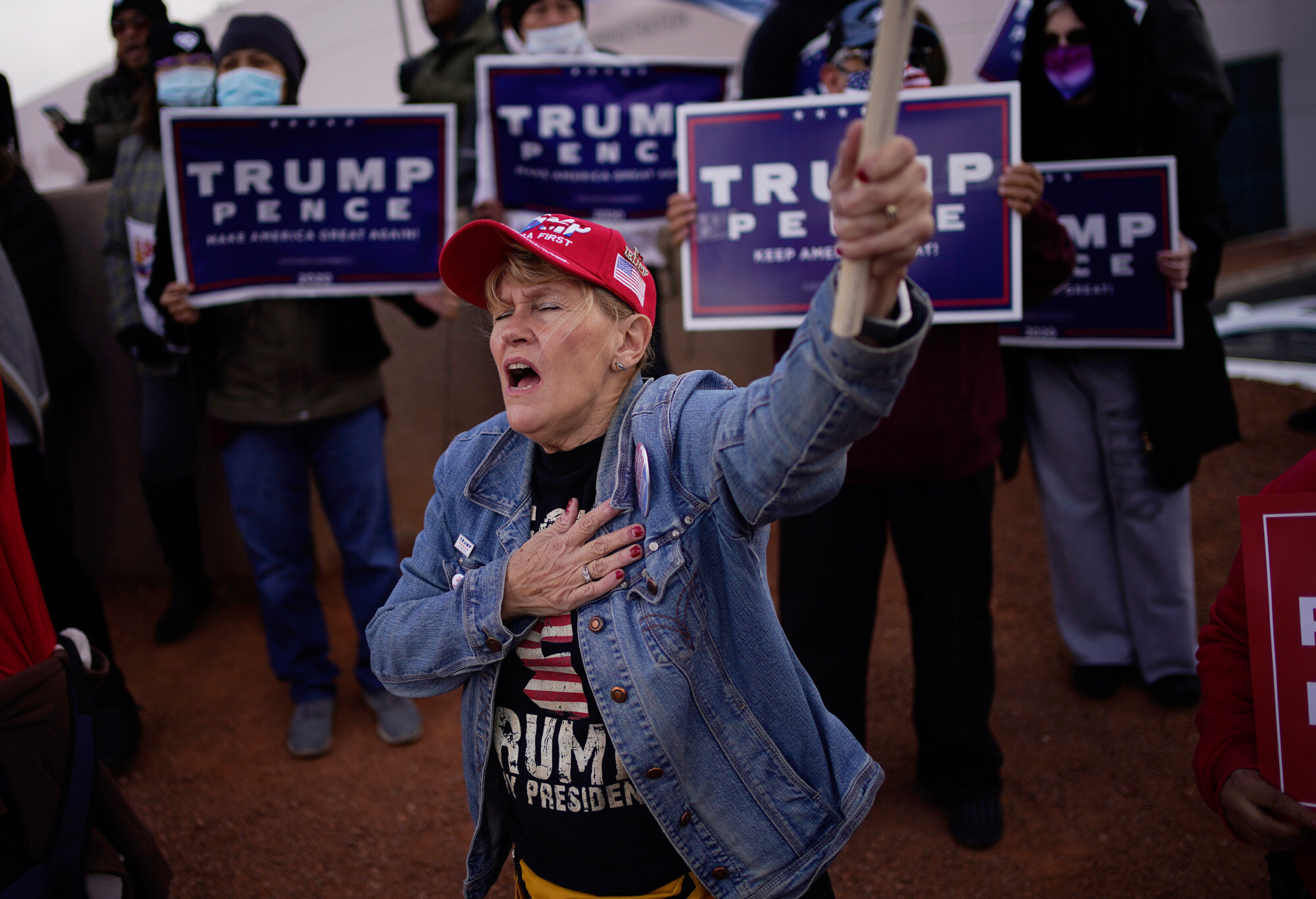  A supporter of President Donald Trump holds her hand over her heart during a protest of the election outside of the Clark County Election Department in North Las Vegas on Nov. 8, 2020. (AP Photo/John Locher) 