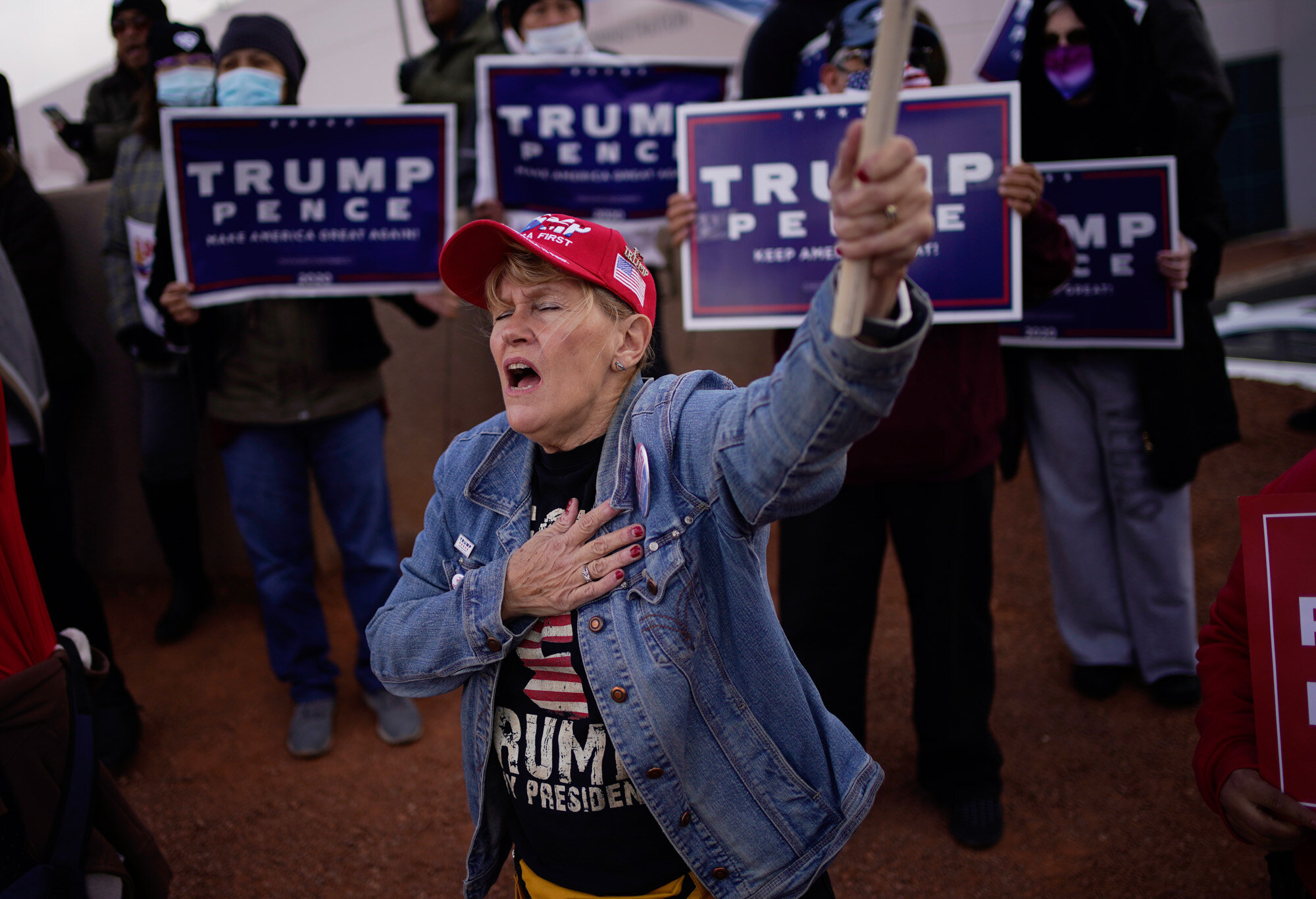 A supporter of President Donald Trump holds her hand over her heart during a protest of the election outside of the Clark County Election Department in North Las Vegas on Nov. 8, 2020. (AP Photo/John Locher)