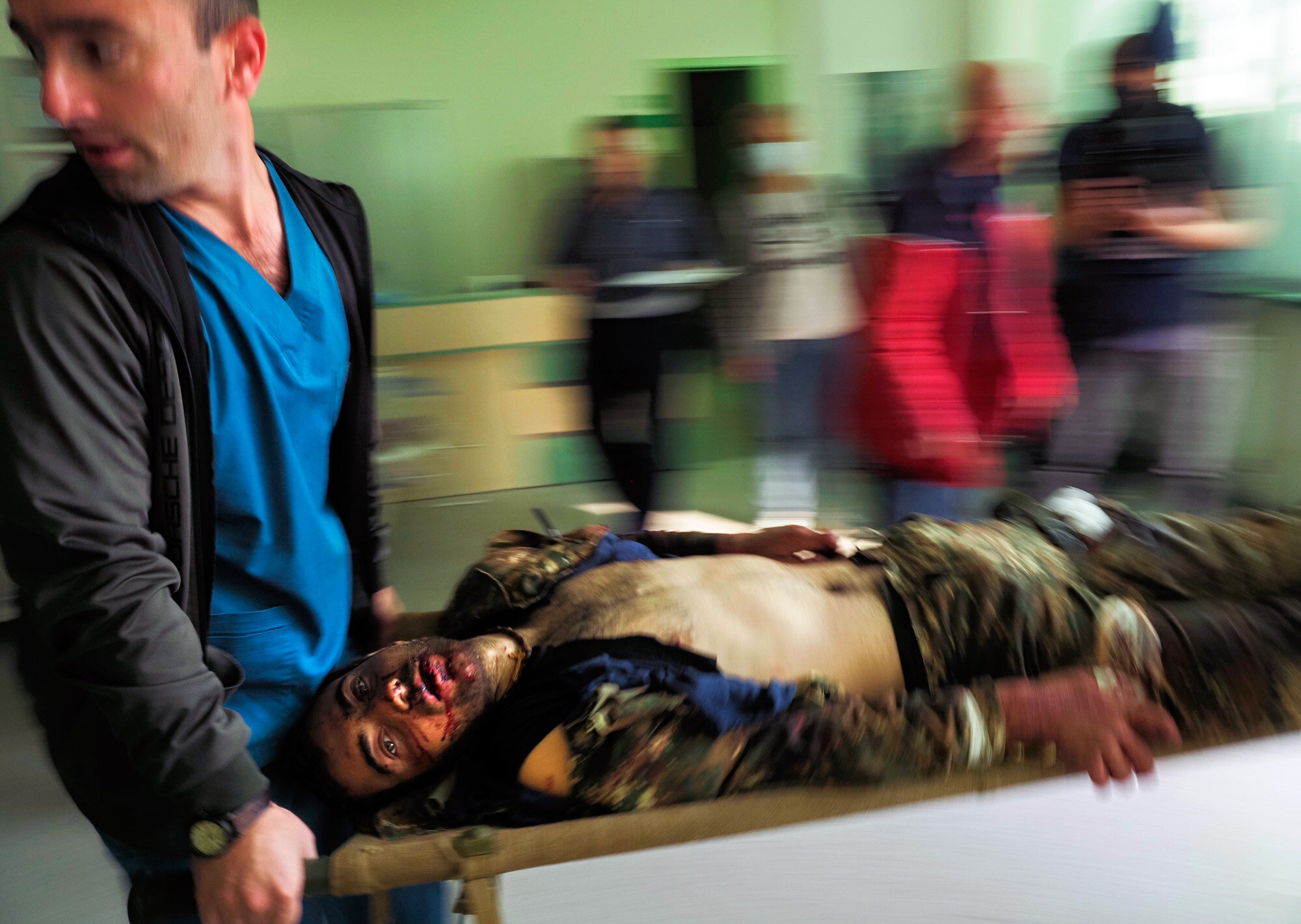 Medical workers transport a wounded man in a hospital during shelling by Azerbaijan's artillery in Stepanakert, in the separatist region of Nagorno-Karabakh, on Oct. 28, 2020. (AP Photo/Dmitry Lovetsky)