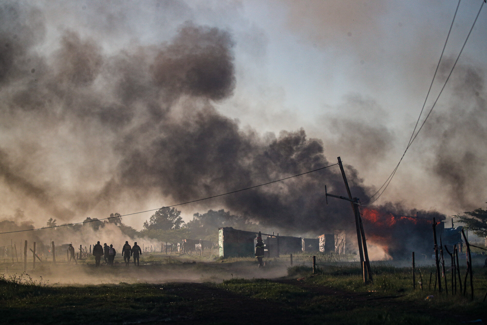 Police carry out an eviction at a squatters camp in Guernica, Buenos Aires province, Argentina, on Oct. 29, 2020. A court ordered the eviction of families who have been squatting here since July, but the families say they have nowhere to go amid the COVID-19 pandemic. (AP Photo/Natacha Pisarenko)