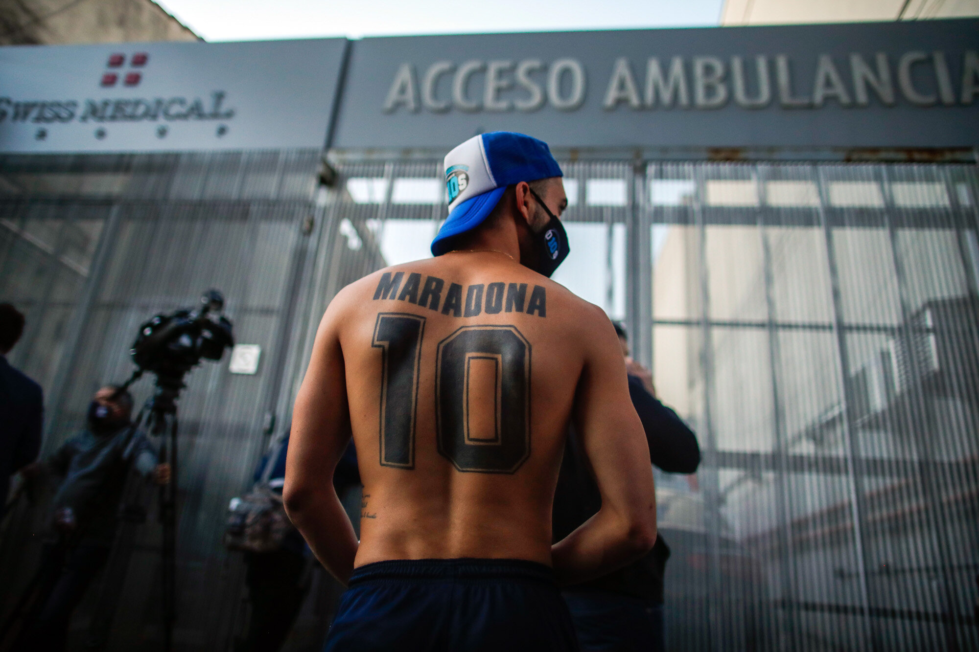 Soccer fans gather outside Clinica Olivos, where former soccer star Diego Maradona will undergo surgery, in Buenos Aires, Argentina, on Nov. 3, 2020. Widely regarded as one of the greatest soccer players of all time, Maradona died on Nov. 25. He was 60. (AP Photo/Natacha Pisarenko)