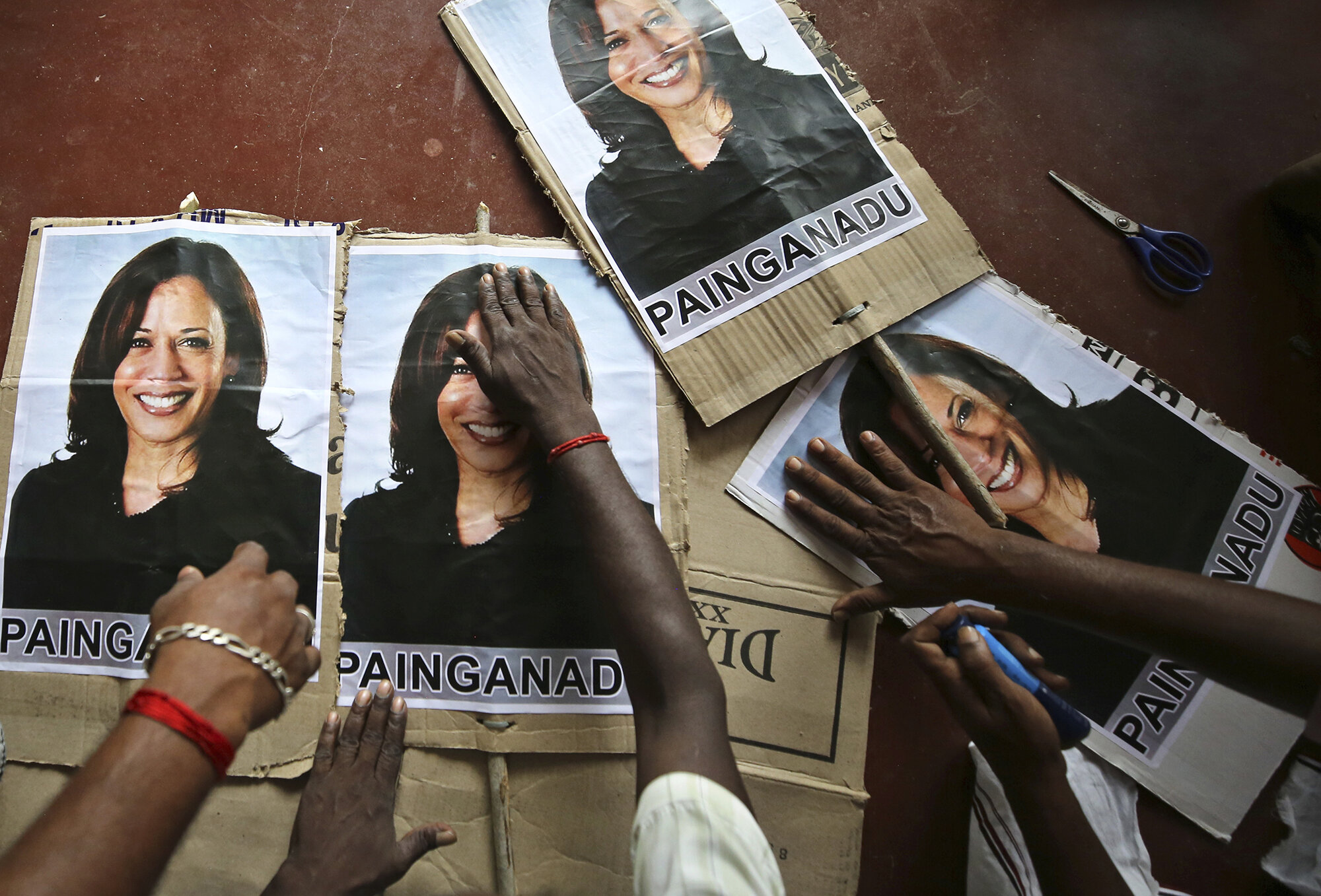 Villagers prepare placards featuring U.S. Democratic vice presidential candidate Sen. Kamala Harris in Painganadu, a neighboring village of Thulasendrapuram, south of Chennai, in Tamil Nadu state, India, Nov. 6, 2020. The lush green village of Thulasendrapuram is the hometown of Harris’ maternal grandfather, who migrated from here decades ago. (AP Photo/Aijaz Rahi)