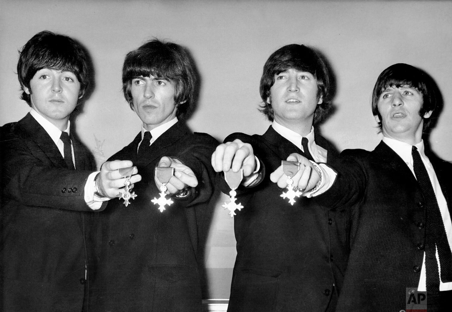  The Beatles pose with their medals during a press conference in London after being made members of the Order of the British Empire, Oct. 26, 1965.  The medals were presented to them by the Queen at Buckingham Palace. (AP Photo) 