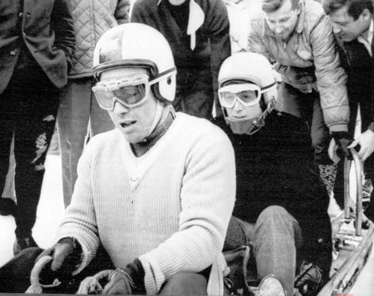  Wearing crash helmet and goggles, Beatle John Lennon, right, sits in the brakeman position for a bobsled ride with British Olympic Gold medallist Tony Nash, at St. Moritz, Switzerland, Feb. 8, 1965. Lennon was on a private skiing holiday with his wi