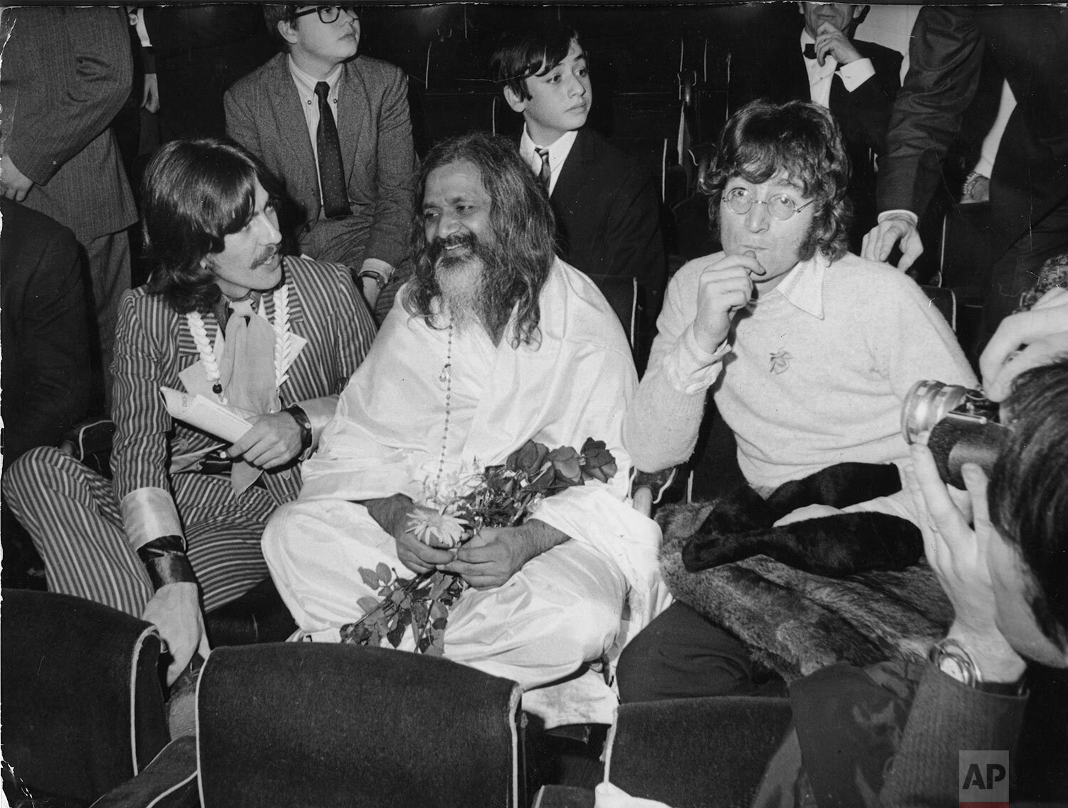  Maharishi Mahesh Yogi, considered as the "spiritual father" of the Beatles sits amidst George Harrison, left and John Lennon, during the UNICEF gala at the Palais du Chaillot in Paris, December 15, 1967. (AP Photo) 