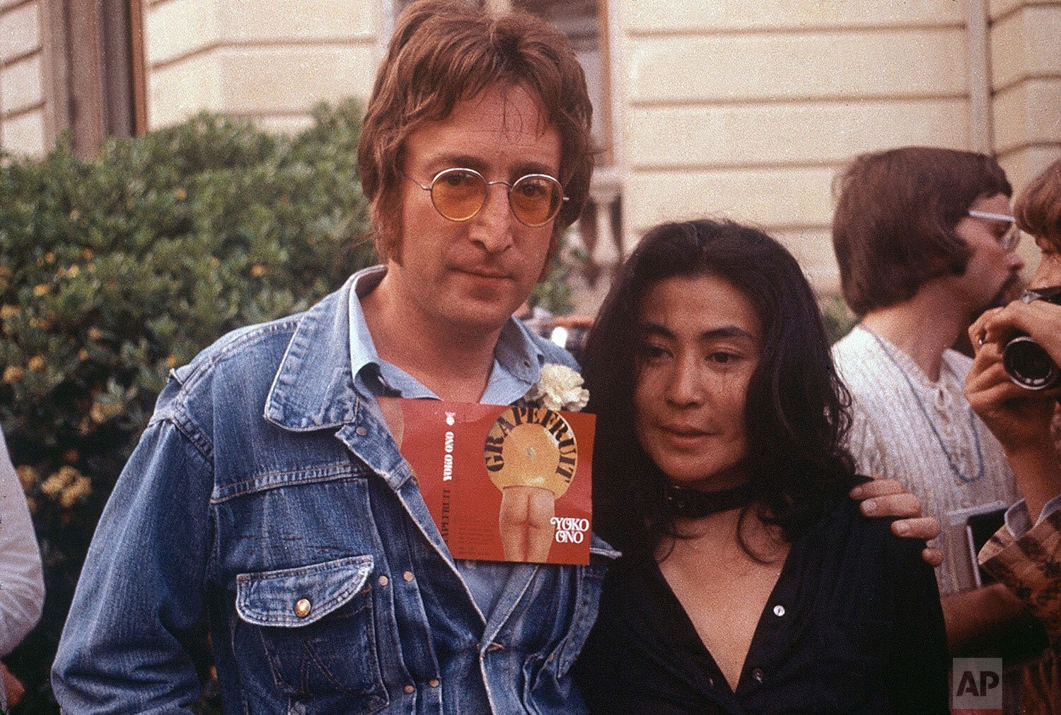  John Lennon and his wife Yoko Ono are seen at the Cannes Film Festival, May 18, 1971.  Lennon carries Ono's art book "Grapefruit" in his jacket. (AP Photo/Michel Lipchitz) 