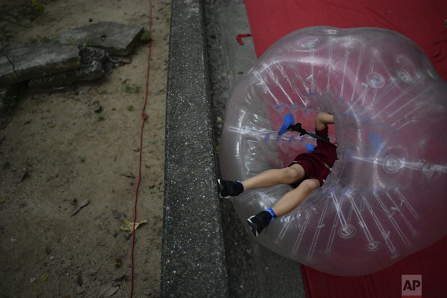  A boy plays inside a large inflatable bubble at Los Caobos public park in Caracas, Venezuela, Sunday, Nov. 8, 2020. (AP Photo/Matias Delacroix) 