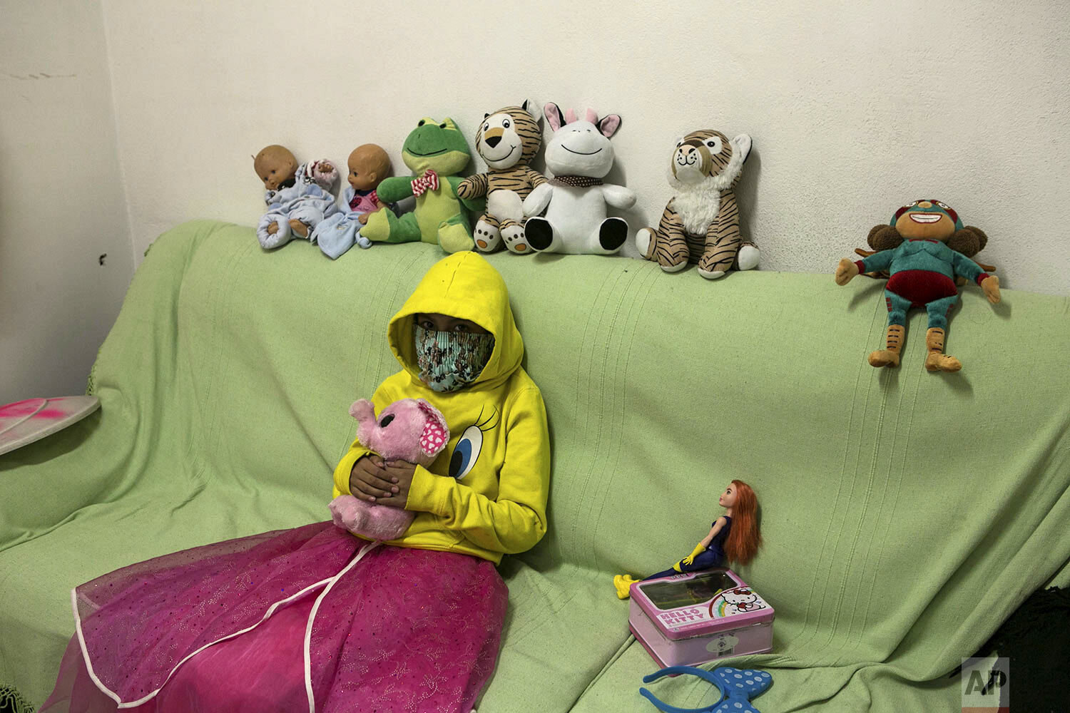  A 10-year-old victim of sexual abuse, who keeps her face covered to hide her identity, poses for a portrait with her stuffed animals inside the Mexican Human Rights Commission (CNDH) headquarters where she has been living with her grandmother, mothe