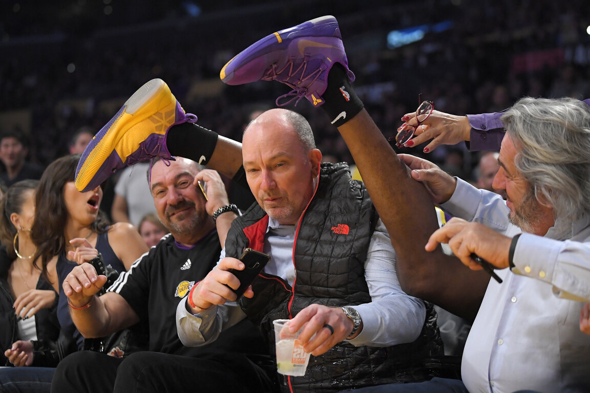  Los Angeles Lakers center Dwight Howard lands on top of fans while chasing a loose ball during the first half of an NBA basketball game against the Orlando Magic Wednesday, Jan. 15, 2020, in Los Angeles. (AP Photo/Mark J. Terrill) 