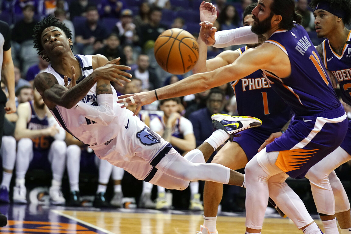  Memphis Grizzlies guard Ja Morant attempts to save the ball in front of Phoenix Suns guard Devin Booker, Kelly Oubre Jr. and Ricky Rubio in the second half during an NBA basketball game, Sunday, Jan. 5, 2020, in Phoenix. (AP Photo/Rick Scuteri) 