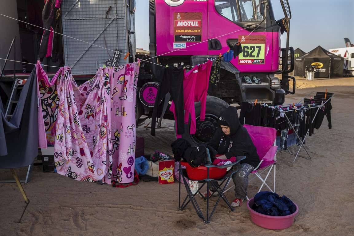  A team member of driver Camelia Liparoti, of Italy, and co-driver Annett Fischer, of Germany, does the laundry after stage eight of the Dakar Rally in Wadi Al Dawasir, Saudi Arabia, Monday, Jan. 13, 2020. (AP Photo/Bernat Armangue) 