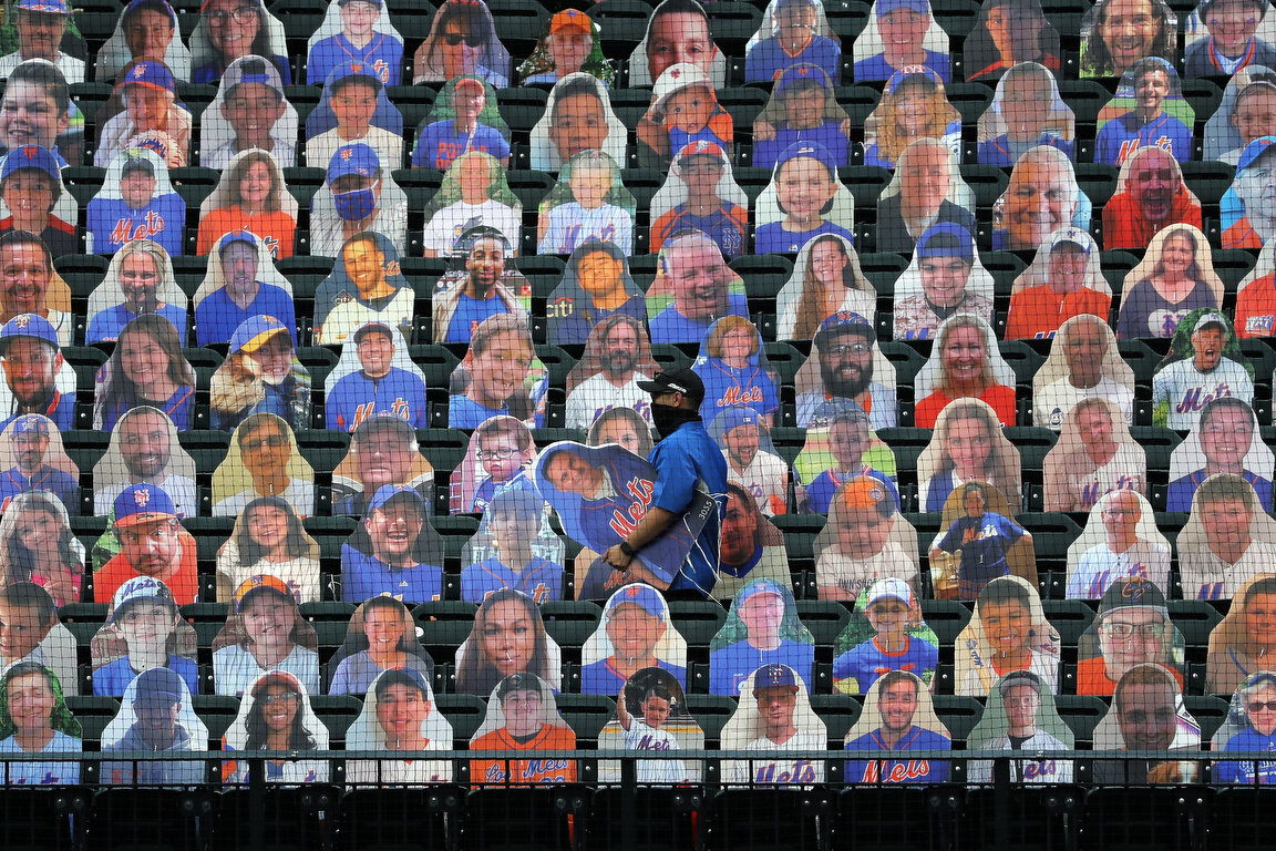 New York Mets employees place cutouts of fans in the seats before the Opening Day baseball game between the Mets and the Atlanta Braves at Citi Field, Friday, July 24, 2020, in New York. (AP Photo/Seth Wenig) 