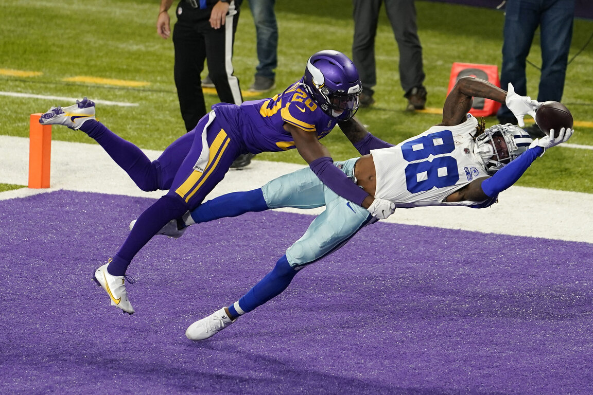  Dallas Cowboys wide receiver CeeDee Lamb  catches a 4-yard touchdown pass ahead of Minnesota Vikings cornerback Jeff Gladney, left, during the first half of an NFL football game, Sunday, Nov. 22, 2020, in Minneapolis. (AP Photo/Jim Mone) 