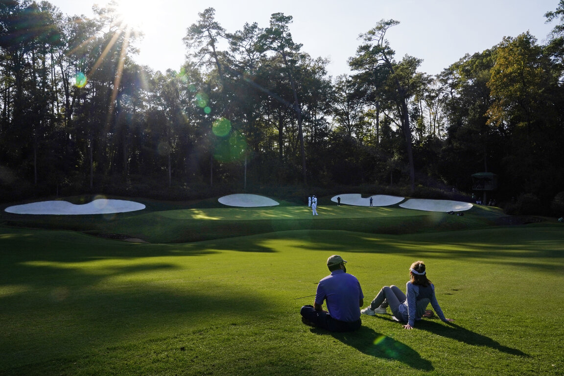  A couple watch as Sungjae Im, of South Korea, Hideki Matsuyama, of Japan, and C.T. Pan, of Taipei, play on the 13th green during the third round of the Masters golf tournament Saturday, Nov. 14, 2020, in Augusta, Ga. (AP Photo/Matt Slocum) 