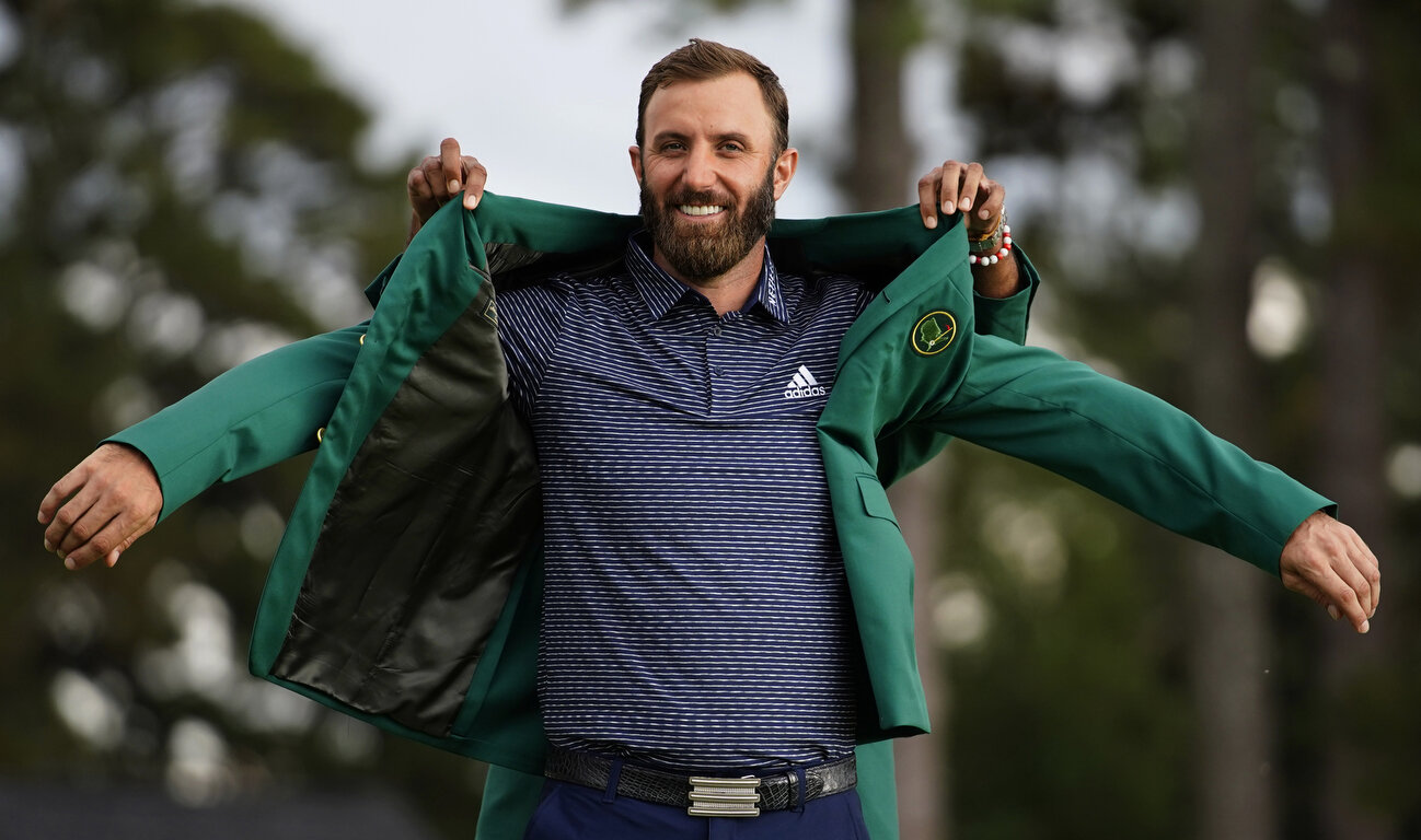  Tiger Woods helps Masters champion Dustin Johnson with his green jacket after his victory at the Masters golf tournament Sunday, Nov. 15, 2020, in Augusta, Ga. (AP Photo/Matt Slocum) 