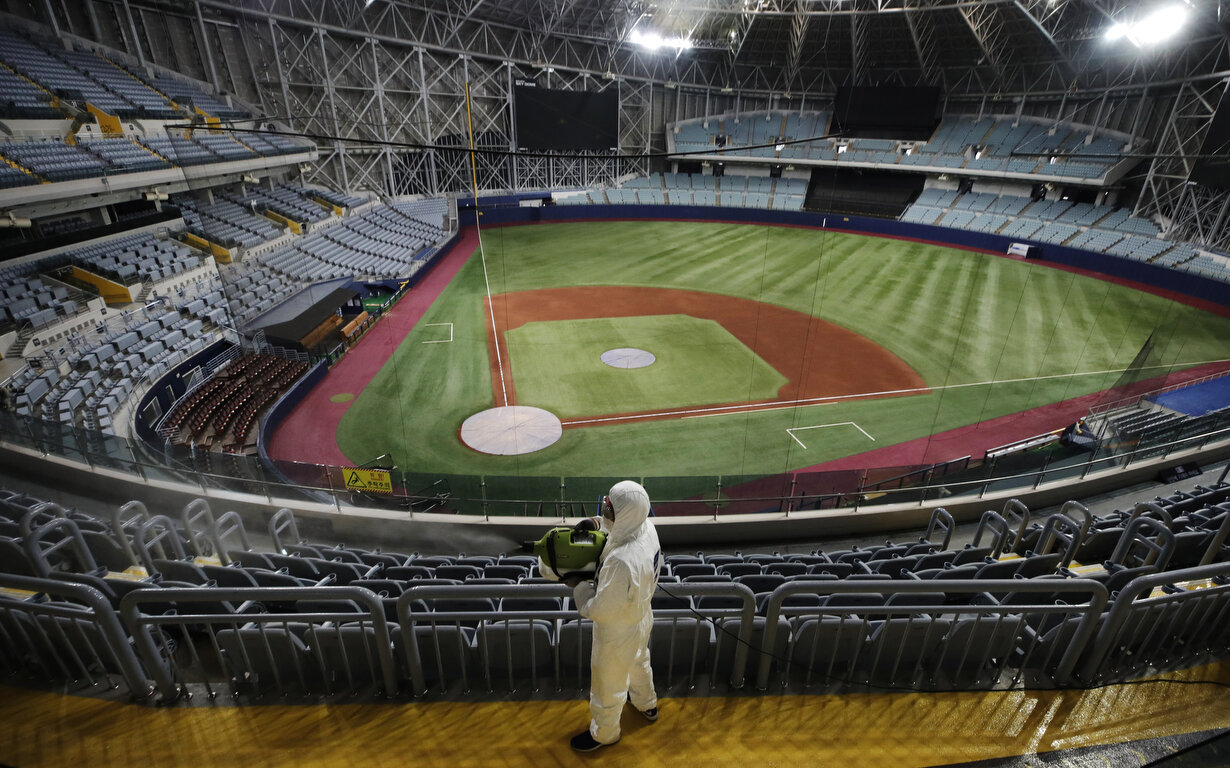  A worker wearing protective gears disinfects as a precaution against the new coronavirus at Gocheok Sky Dome in Seoul, South Korea, Tuesday, March 17, 2020. The Korea Baseball Organization has postponed the start of new season to prevent the spread 