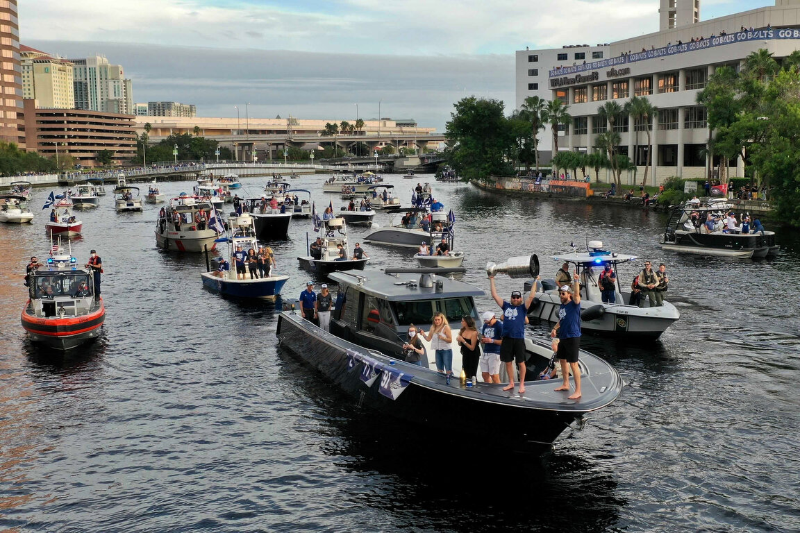  Members of the Tampa Bay Lightning make their way down the Hillsborough River as they are greeted by fans during the NHL hockey Stanley Cup champions' boat parade, Wednesday, Sept. 30, 2020, in Tampa, Fla. (Luis Santana/Tampa Bay Times via AP) 