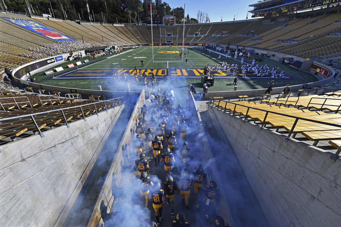  The California Golden Bears run into an empty Memorial Stadium for the 123rd Big Game, an NCAA college football game against Stanford Friday, Nov. 27, 2020, in Berkeley, Calif. (Jose Carlos Fajardo/Bay Area News Group via AP) 