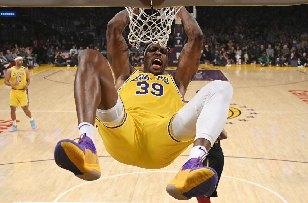  Los Angeles Lakers center Dwight Howard hangs on the basket as he dunks during the first half of an NBA basketball game against the Cleveland Cavaliers Monday, Jan. 13, 2020, in Los Angeles. (AP Photo/Mark J. Terrill) 