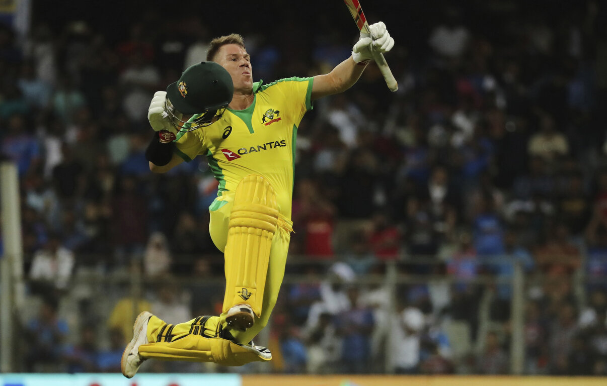  Australia's David Warner celebrates after scoring a hundred during the first one-day international cricket match between India and Australia in Mumbai, India, Tuesday, Jan. 14, 2020. (AP Photo/Rafiq Maqbool) 