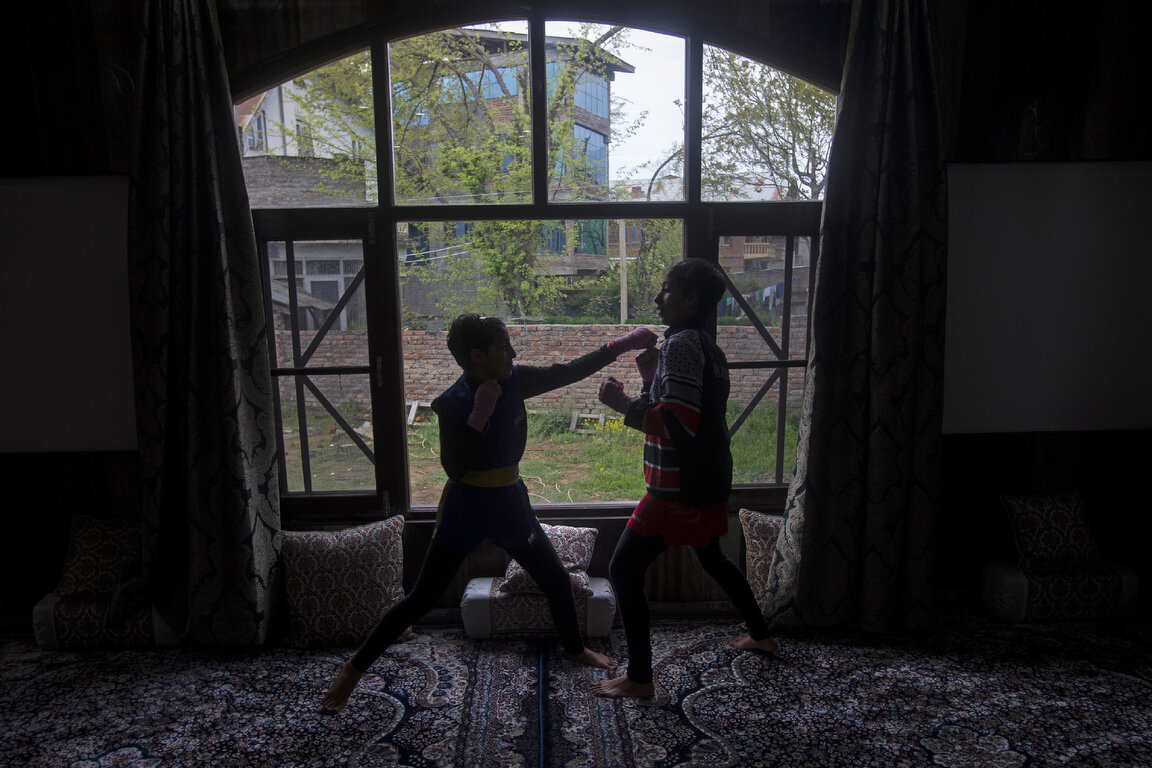  Kashmiri wushu artist Aliza Shah, left, practices along with her sister Kaifa Shah inside their home in Srinagar, Indian controlled Kashmir, April 19, 2020. Like many other athletes, the coronavirus pandemic has restricted the sisters to their home.