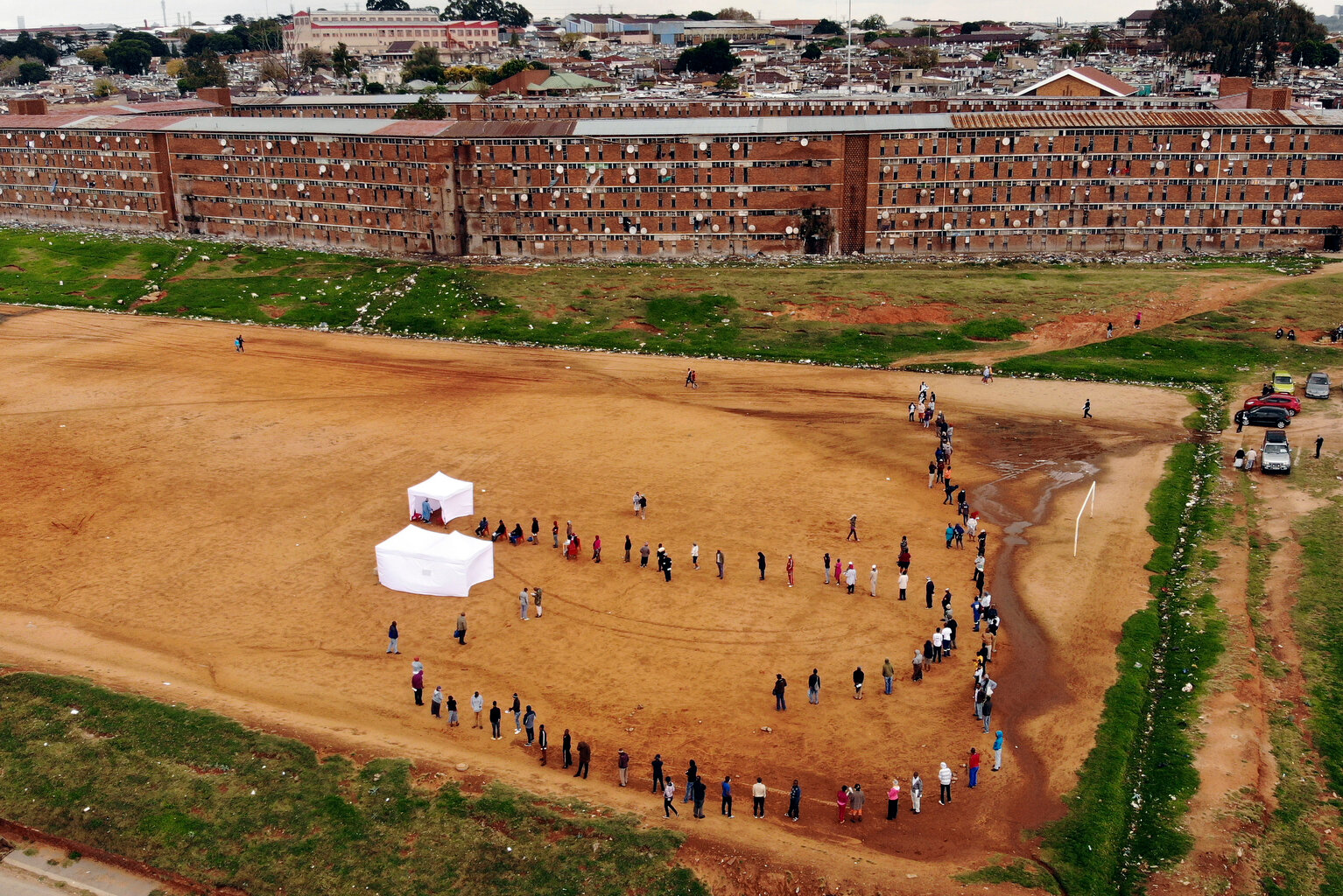  Residents from the Alexandra township in Johannesburg gather in a stadium to be tested for COVID-19 Wednesday, April 29, 2020. It was just a question of time until Africa would fall prey to the COVID-19 pandemic. Already seasoned by years of conflic