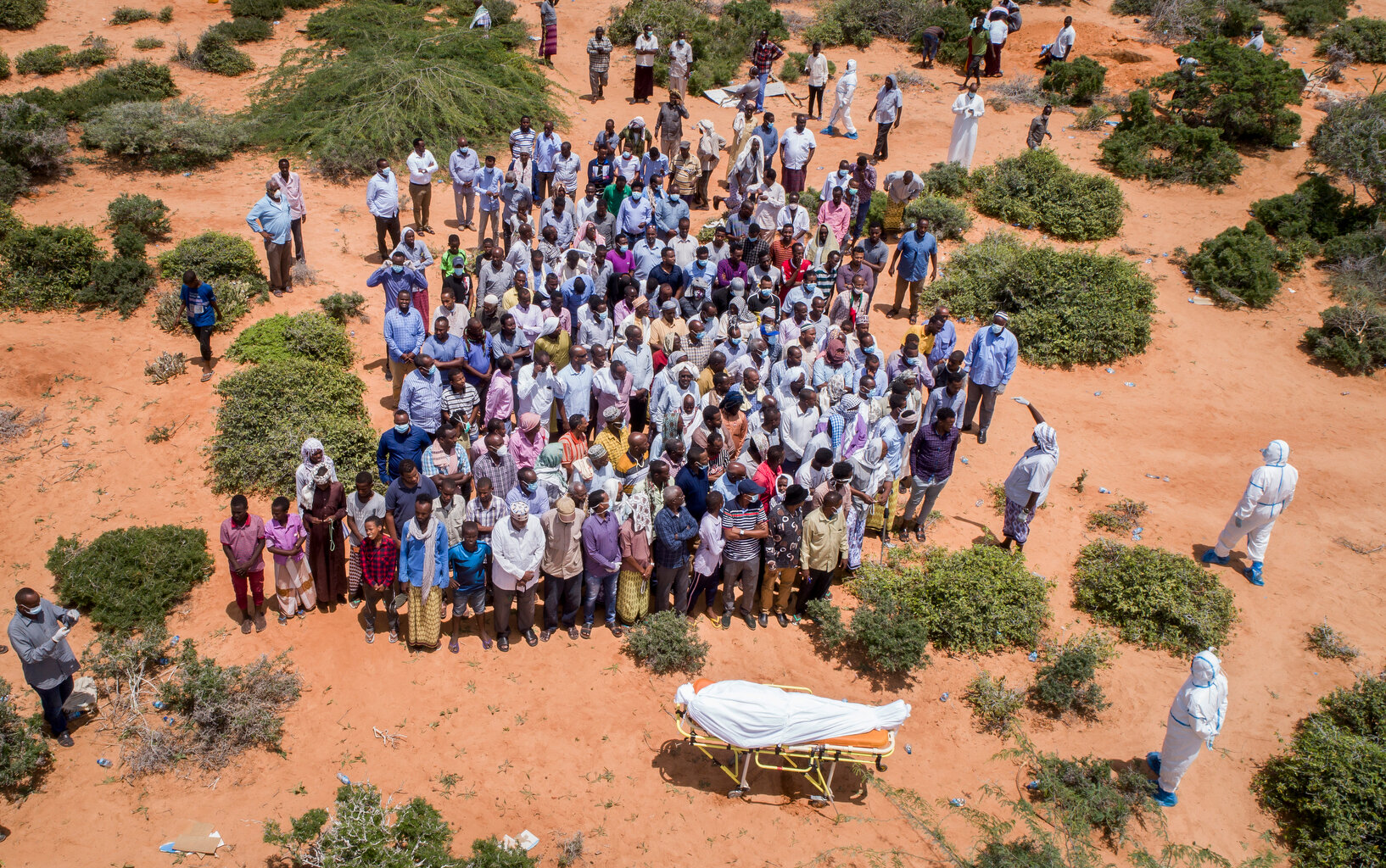  In this photo taken Thursday, April 30, 2020, mourners gather to bury an elderly man believed to have died of the coronavirus in Mogadishu, Somalia. Years of conflict, instability and poverty have left Somalia ill-equipped to handle a health crisis 