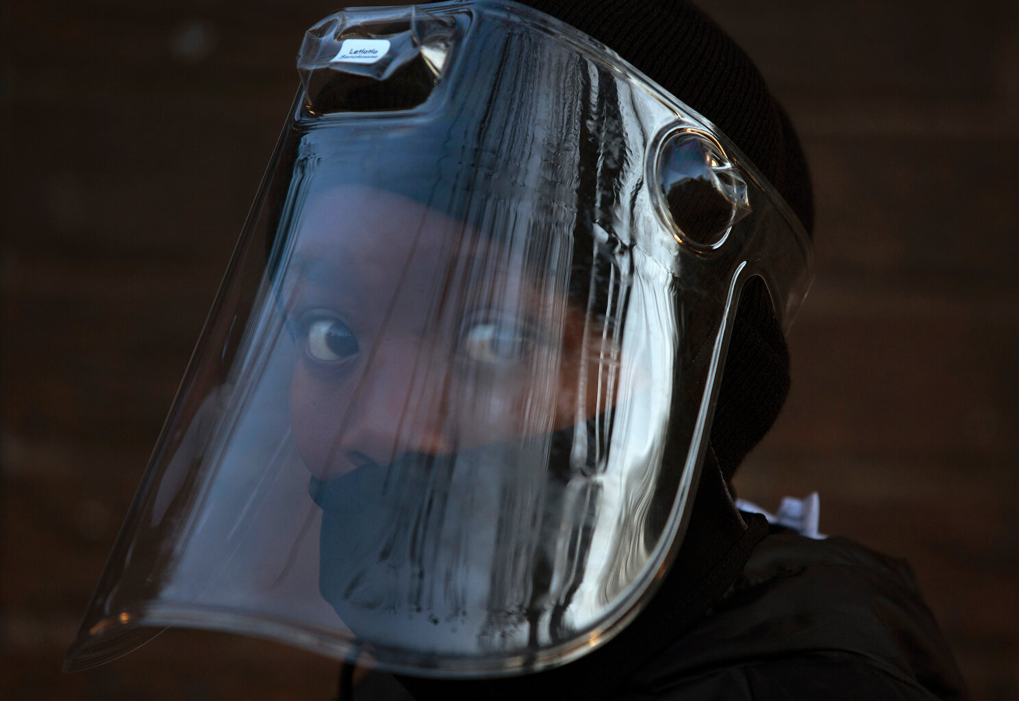  A student, wearing a face mask and shield to protect against the spread of COVID-19, returns to the Melpark Primary School in Johannesburg, Monday Aug. 24, 2020. (AP Photo/Denis Farrell) 