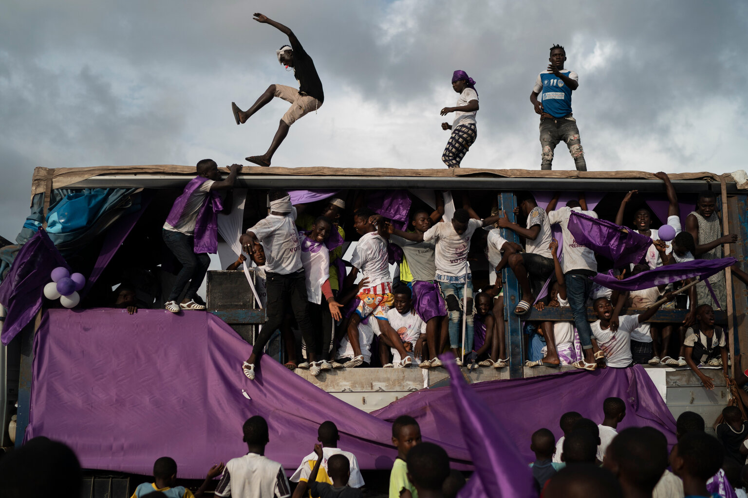  Supporters of the presidential candidate Kouadio Konan Bertin, dance over a sound truck during the final campaign rally in Abidjan, Ivory Coast, Thursday, Oct. 29, 2020. (AP Photo/Leo Correa) 