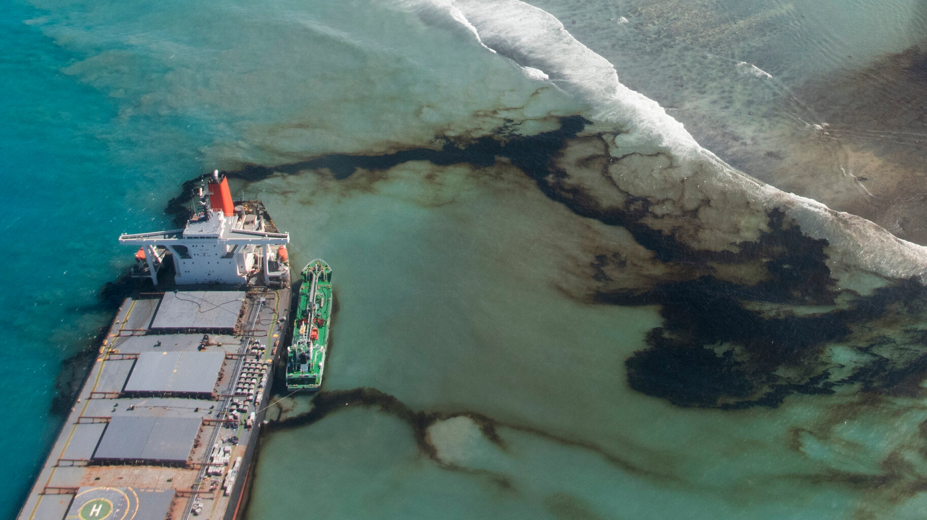  This Tuesday, Aug. 11, 2020 photo provided by the French Army shows oil leaking from the MV Wakashio, a bulk carrier ship that ran aground on a coral reef off the southeast coast of Mauritius. (Gwendoline Defente/EMAE via AP) 