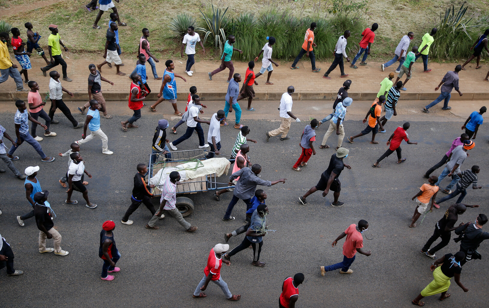  Residents protest with the covered dead body of a man, who they claimed had been beaten by police for being outside during the dusk to dawn curfew, but which could not be independently verified, in the Mathare slum, or informal settlement, of Nairob