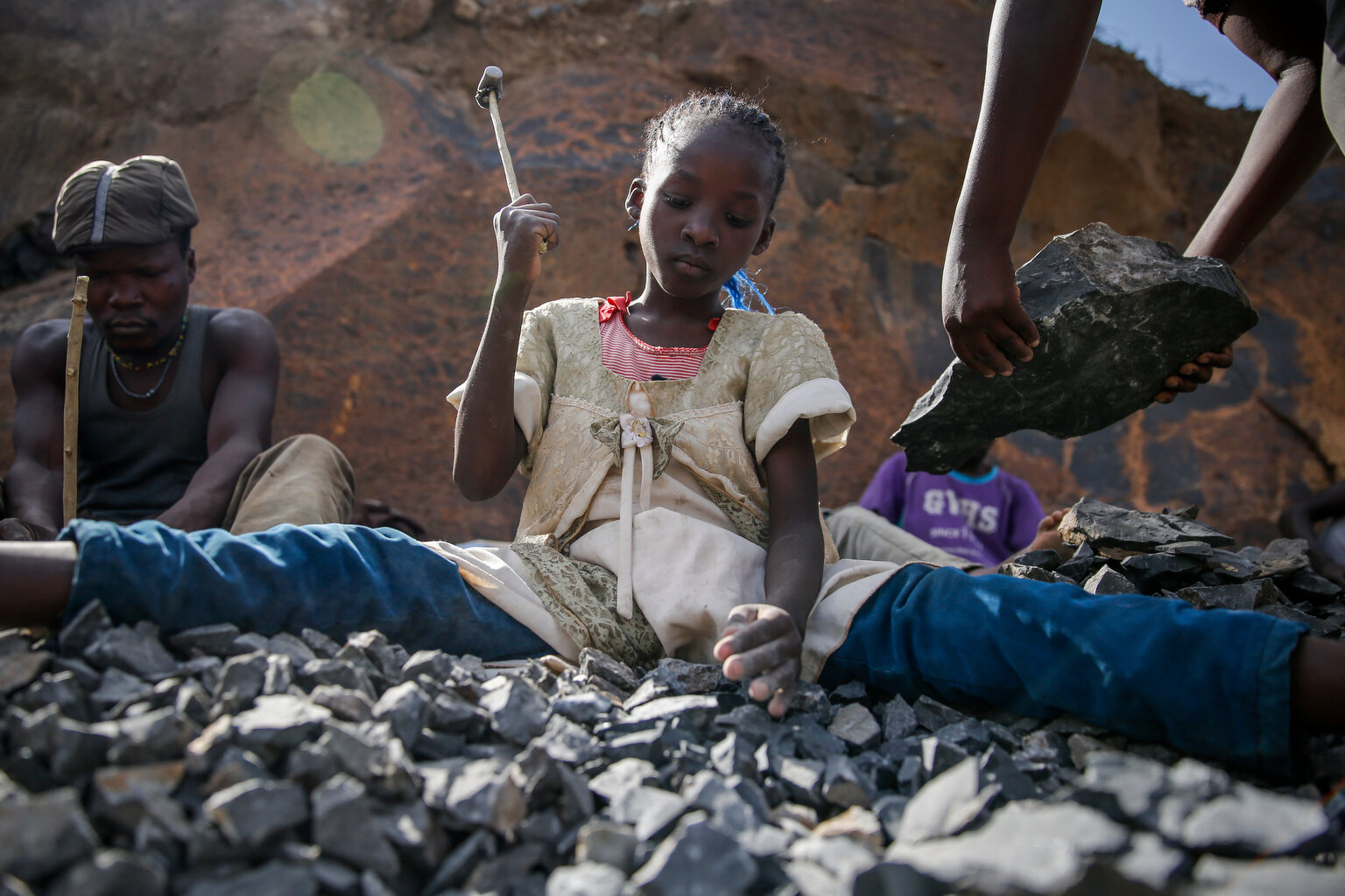  Irene Wanzila, 10, works breaking rocks with a hammer along with her younger brother, older sister and mother, who says she was left without a choice after she lost her cleaning job at a private school when coronavirus pandemic restrictions were imp