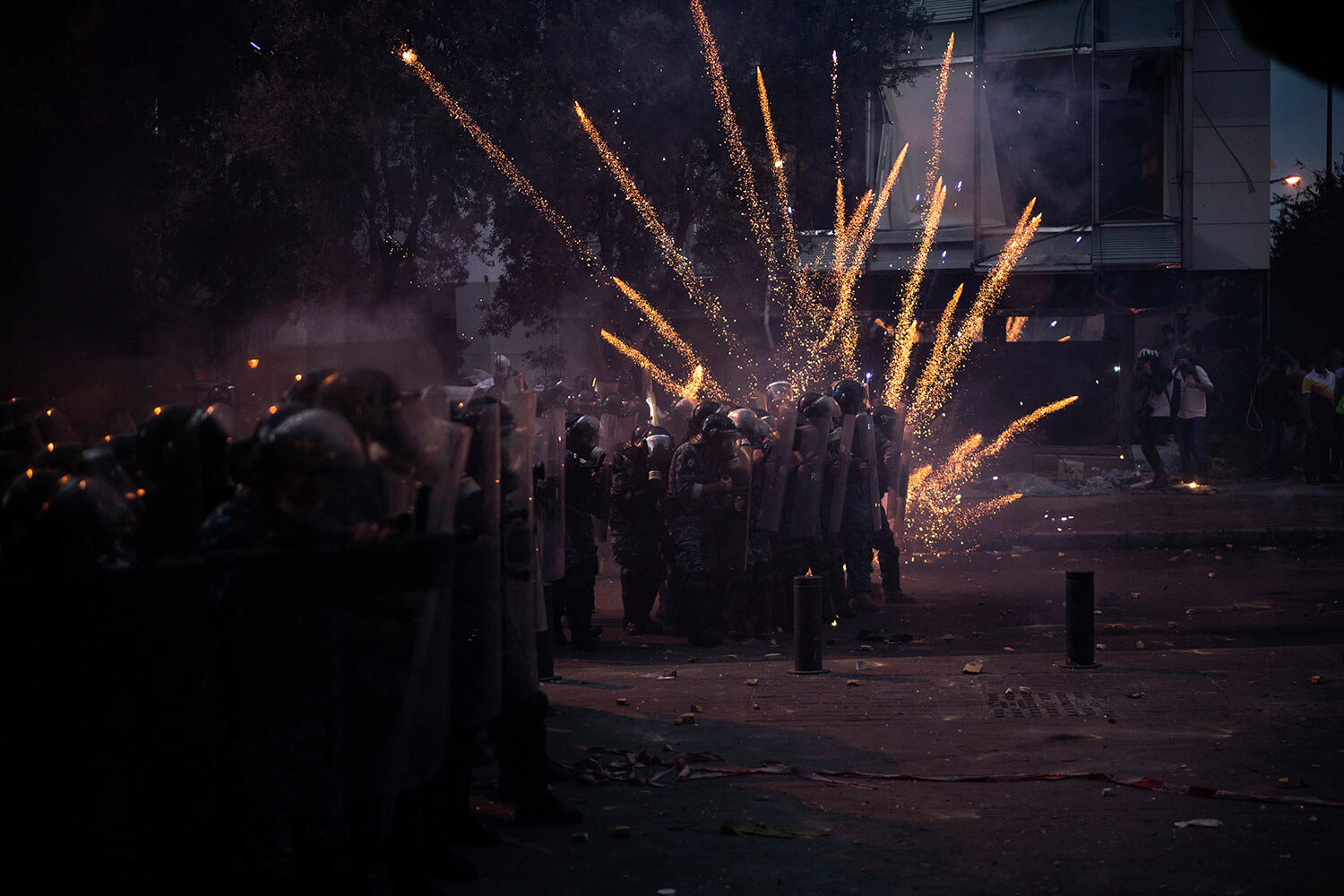  Fireworks thrown by anti-government protesters explode over Riot Police during clashes near the parliament building following a massive explosion on Aug. 4 in the seaport which devastated Beirut, Lebanon, Monday, Aug. 10, 2020. (AP Photo/Felipe Dana