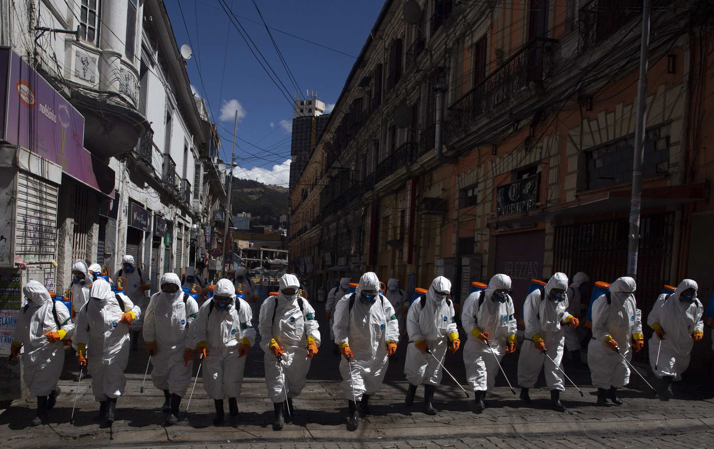  City workers fumigate a street to help contain the spread of the new coronavirus in La Paz, Bolivia, Thursday, April 2, 2020. (AP Photo/Juan Karita) 