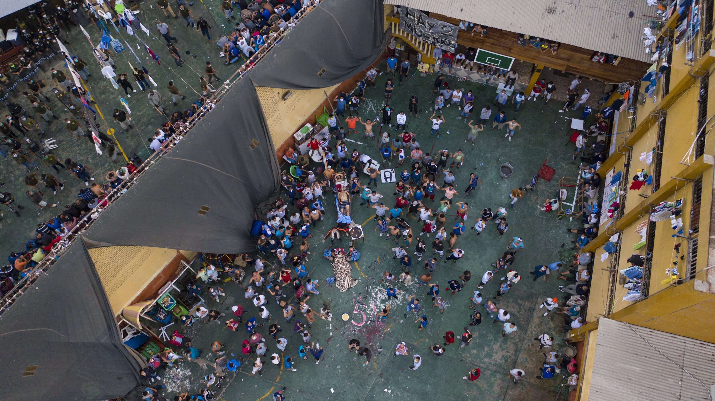  Inmates gather around the corpses of other inmates during a riot at Miguel Castro Castro prison, in Lima, Peru, Monday, April 27, 2020. Peru's prison agency reported that three prisoners died from causes still under investigation after a riot at the