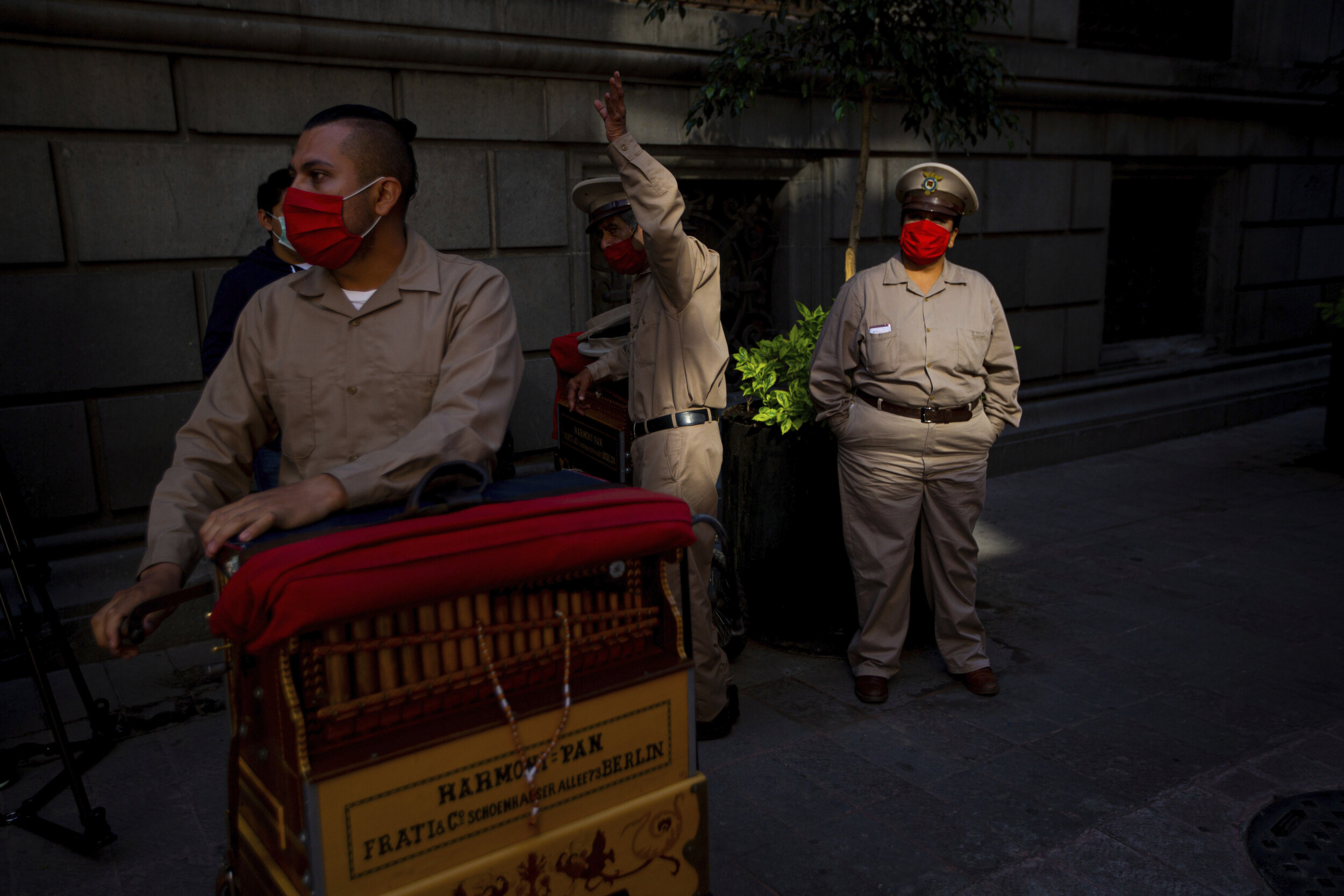  Organ grinders who have lost their ability to earn tips in the street due to restrictions to curb the new coronavirus wait for donated groceries in Mexico City, Thursday, June 4, 2020. (AP Photo/Fernando Llano) 